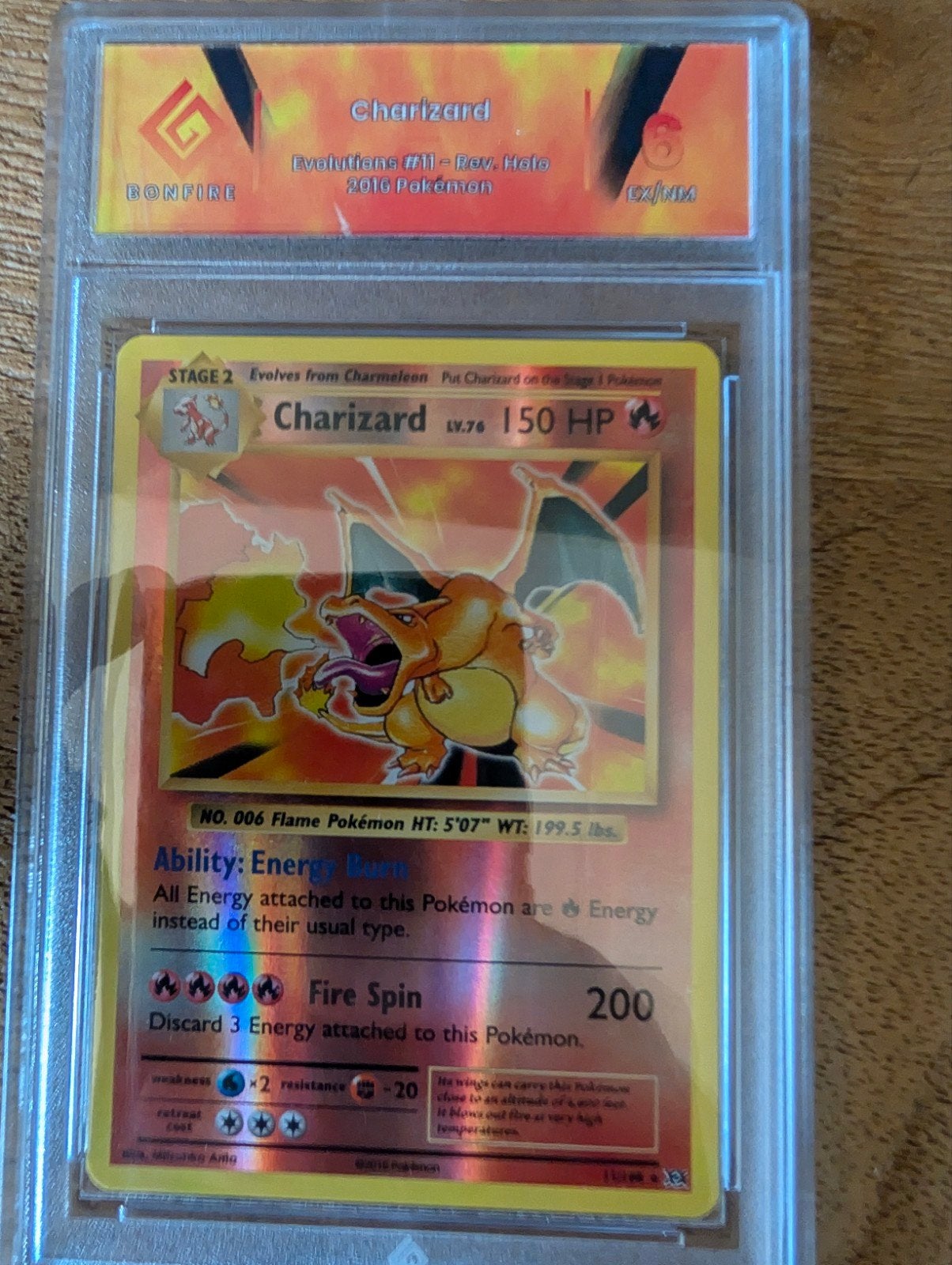 Charizard 11/108 Evolutions Holo Bonfire Graded, Ophalen of Verzenden, Zo goed als nieuw, Losse kaart, Foil