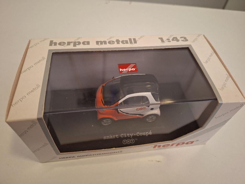 Herpa Smart TNT (nr. D-90599), Hobby en Vrije tijd, Modelauto's | 1:43, Ophalen of Verzenden, Zo goed als nieuw, Auto, Overige merken