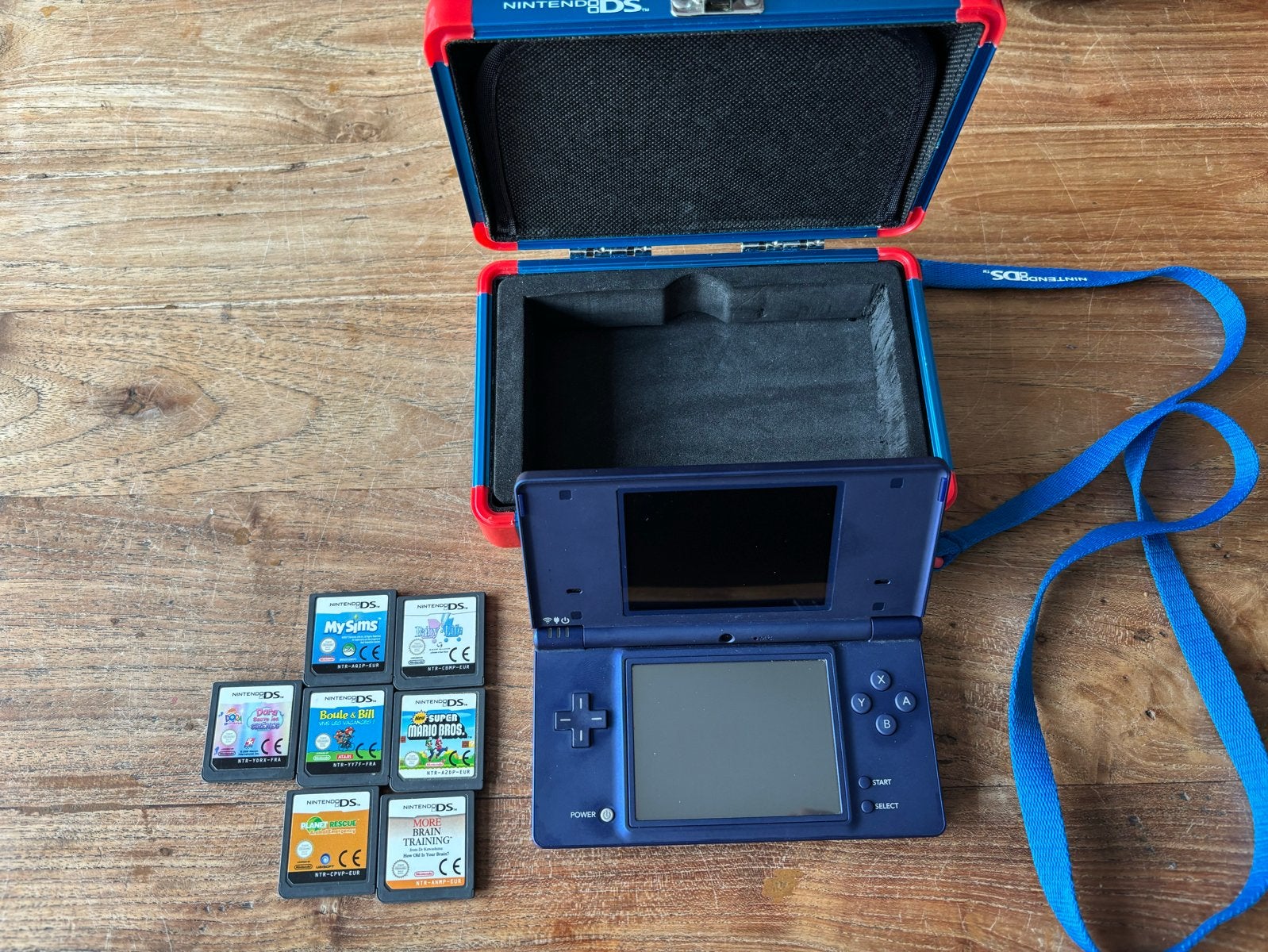 Nintendo DSi met opbergbox, voeding en 7 games, Blauw, Dsi, Ophalen of Verzenden, Gebruikt