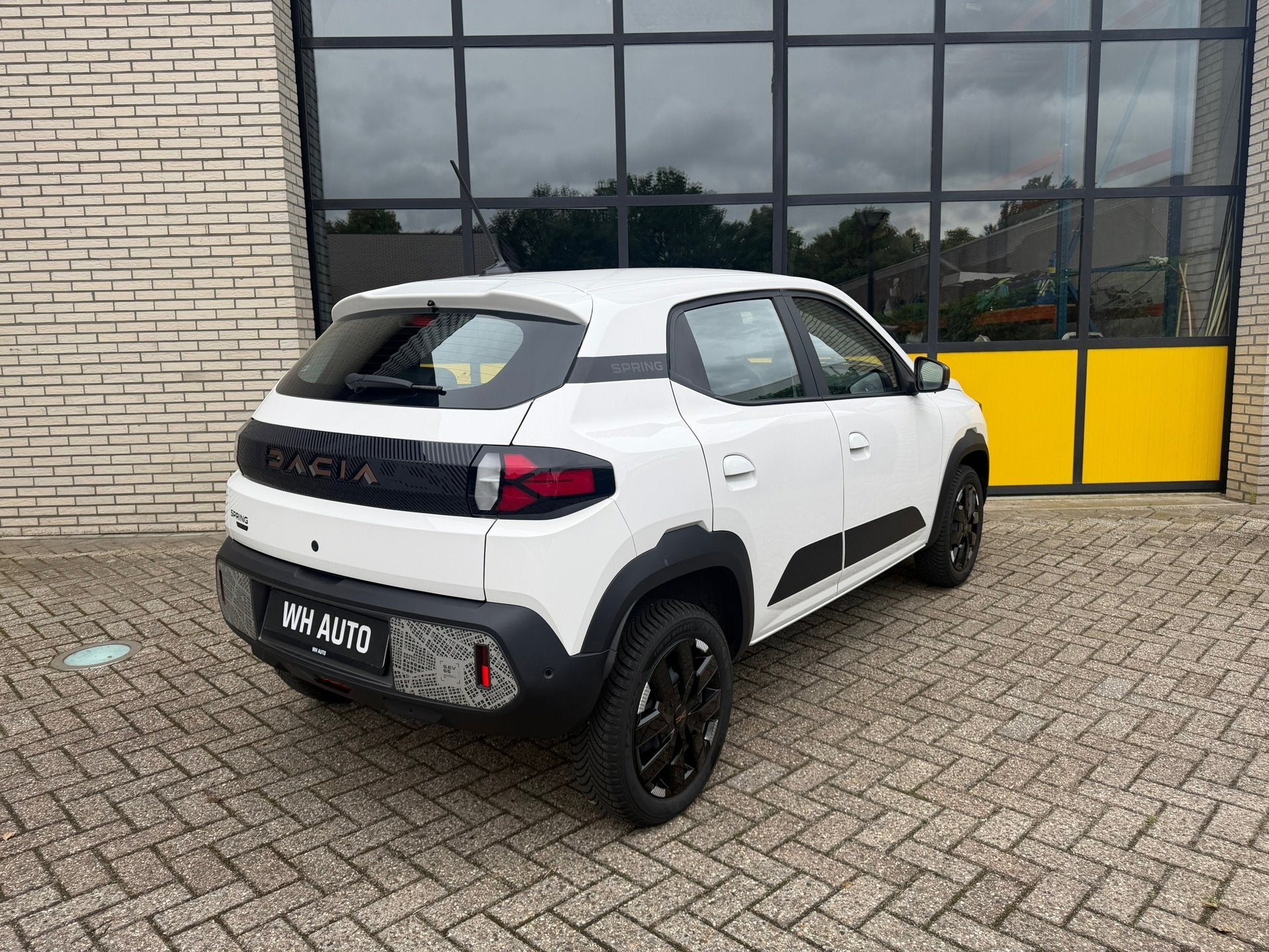 Dacia Spring Extreme 65 26.8 kWh Full Option!, Auto's, Dacia, Stof, Gebruikt, 4 stoelen, Wit