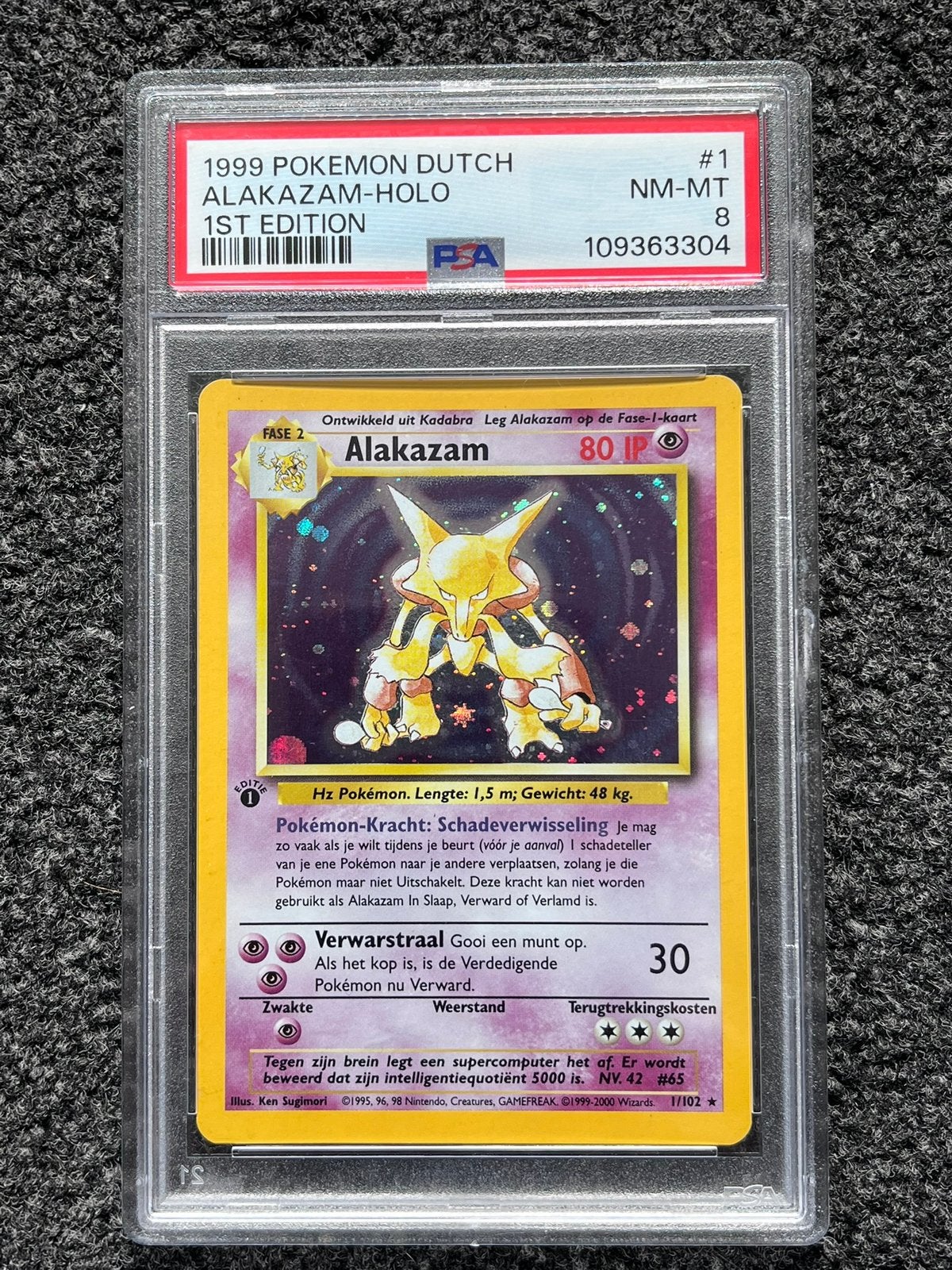 Pokémon PSA 8 1st edition Dutch Alakazam Holo #1 Base set, Ophalen of Verzenden, Zo goed als nieuw, Losse kaart, Foil