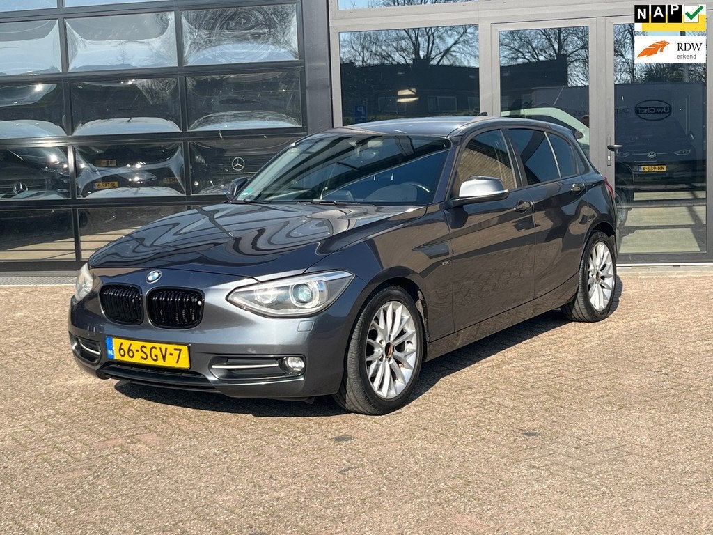 BMW 1-serie 116i Sport-Line , Leer, Nwe APK, Auto's, BMW, 1-Serie, Euro 5, Gebruikt, Zwart
