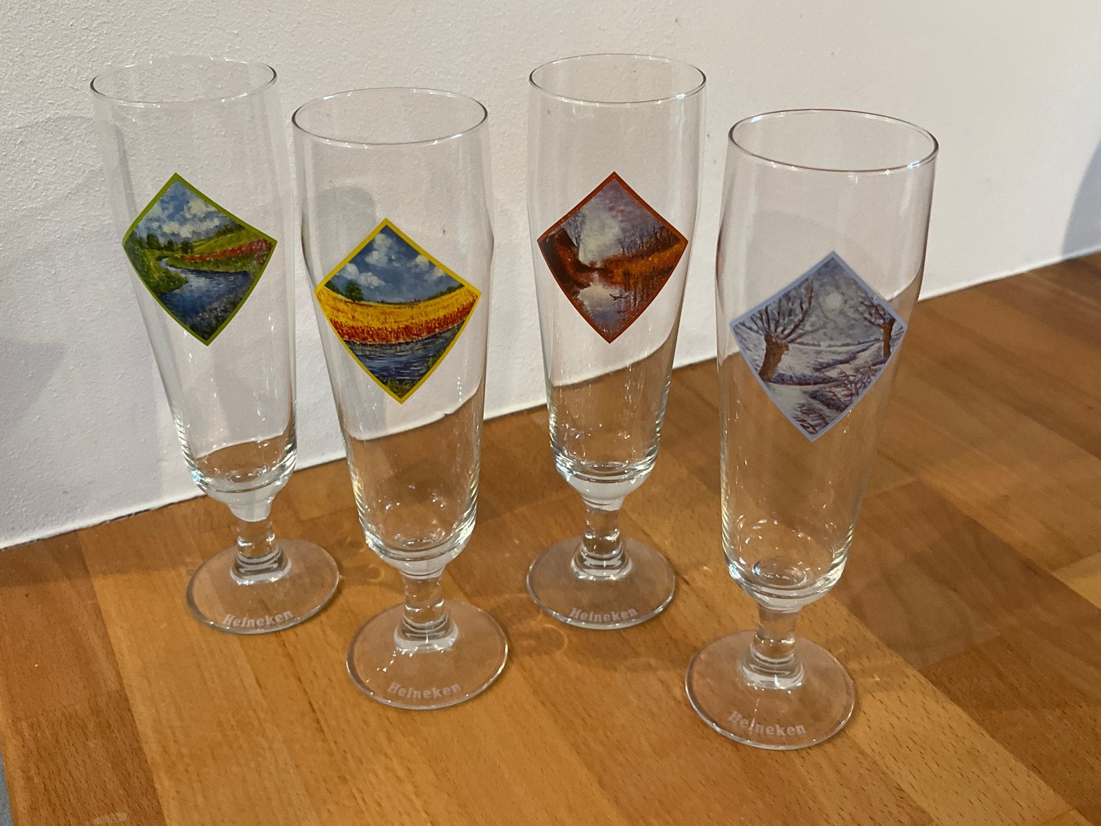 Heineken bierglazen met seizoensafbeeldingen - set van 4, Ophalen of Verzenden, Gebruikt, Glas of Glazen, Heineken