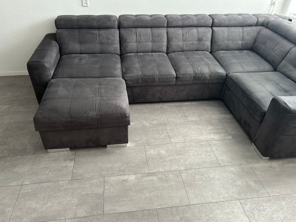 Grijze antraciet hoekbank met poef, Ophalen, 125 cm of meer, 125 cm of meer, Zo goed als nieuw