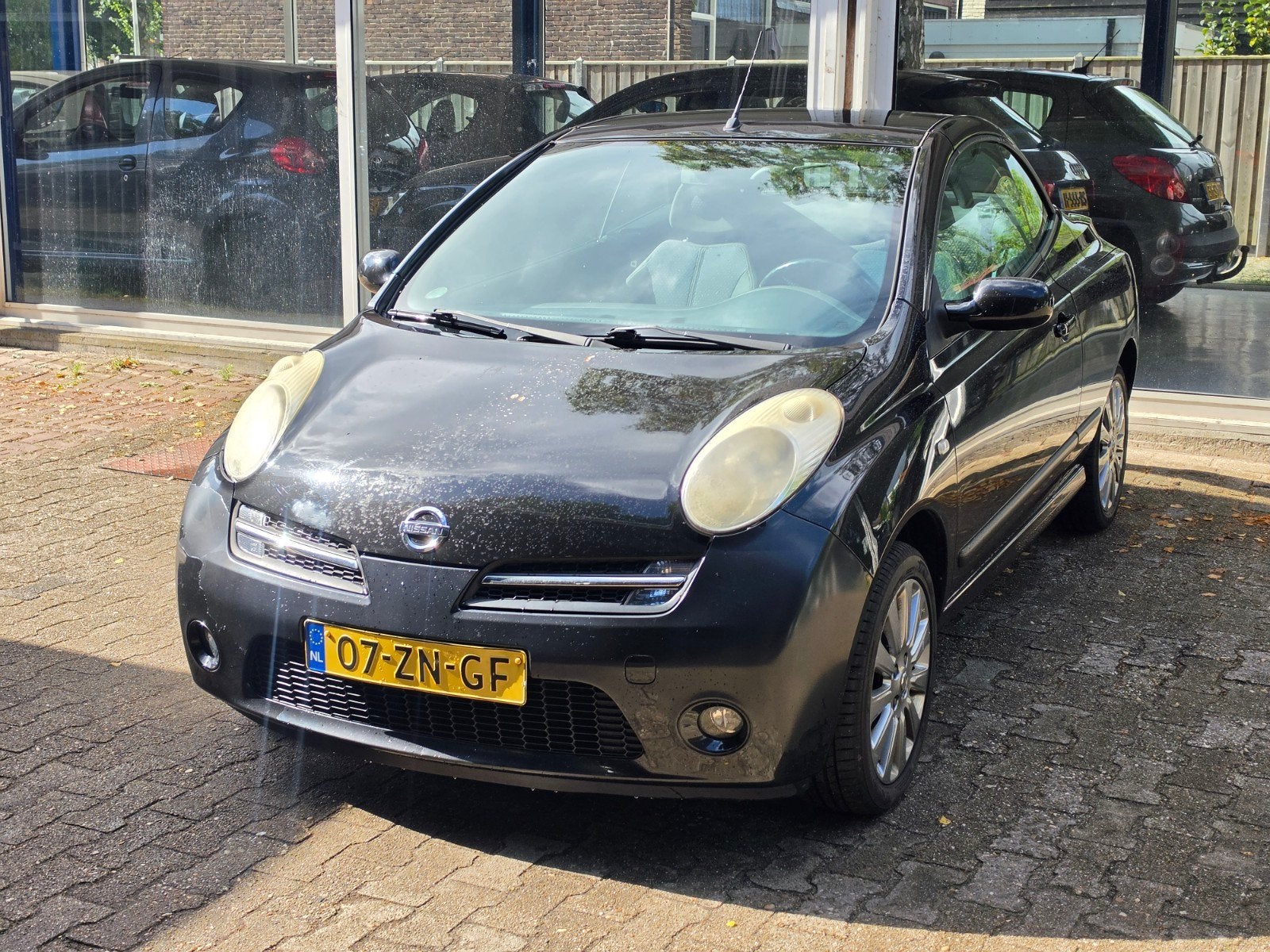 Nissan Micra 1.6 Cabrio 2008 Zwart, Auto's, Voorwielaandrijving, 15 km/l, 750 kg, 4 cilinders
