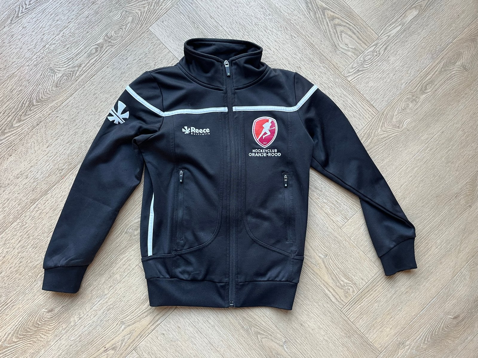 Reece Jasje/Vestje HC Oranje-Rood Maat 128, Sport en Fitness, Ophalen, Zo goed als nieuw, Kleding