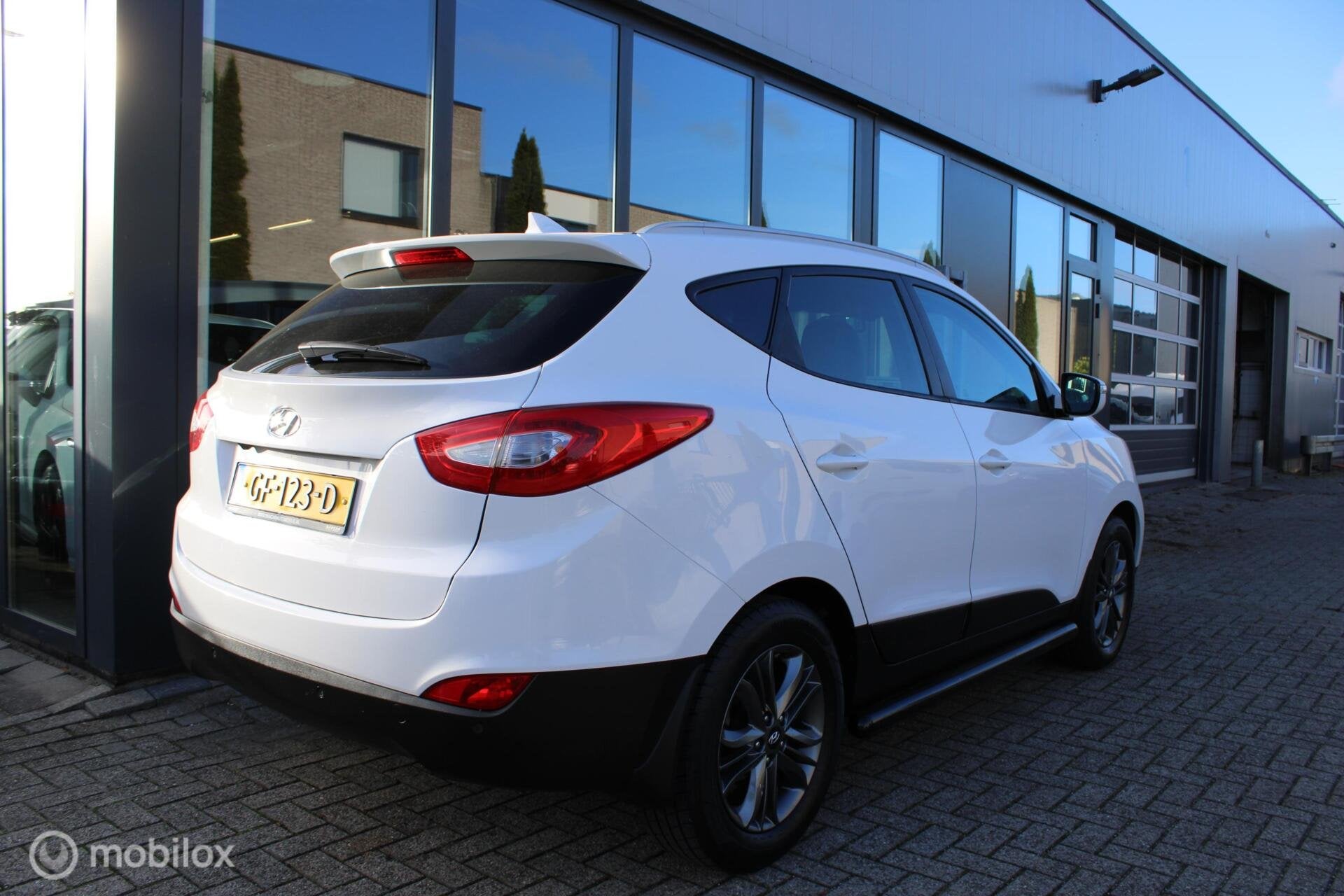 Hyundai ix35 1.6i GDI Go! Camera|Navi|Half-leder|NL-Auto, Auto's, Voorwielaandrijving, Euro 5, 4 cilinders, Wit