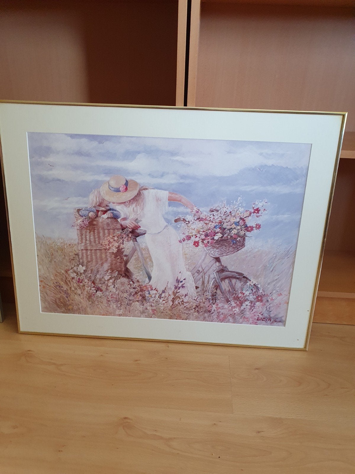 Schilderij 'Vrouw met fiets in bloemenveld' gesigneerd Lidia, Antiek en Kunst, Ophalen