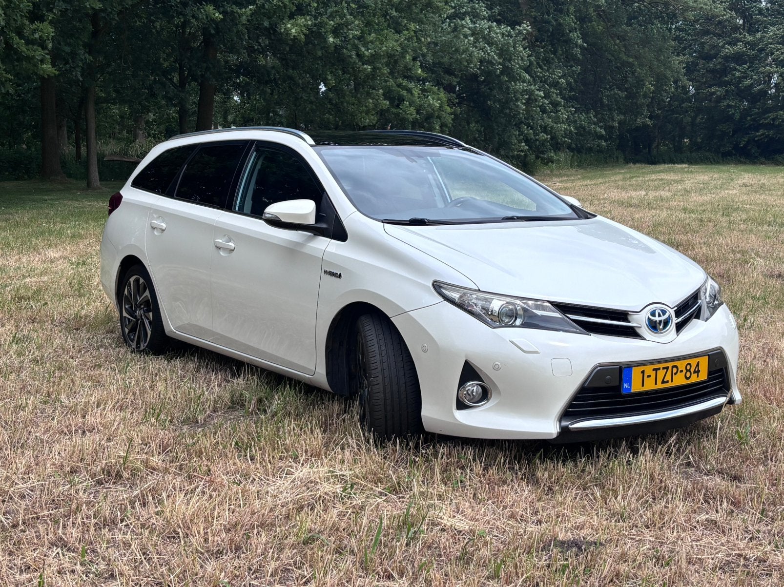 Toyota Auris 1.8 Hybrid Touring Sports CVT 2014 Wit, Auto's, 345 kg, Wit, Origineel Nederlands, 1798 cc