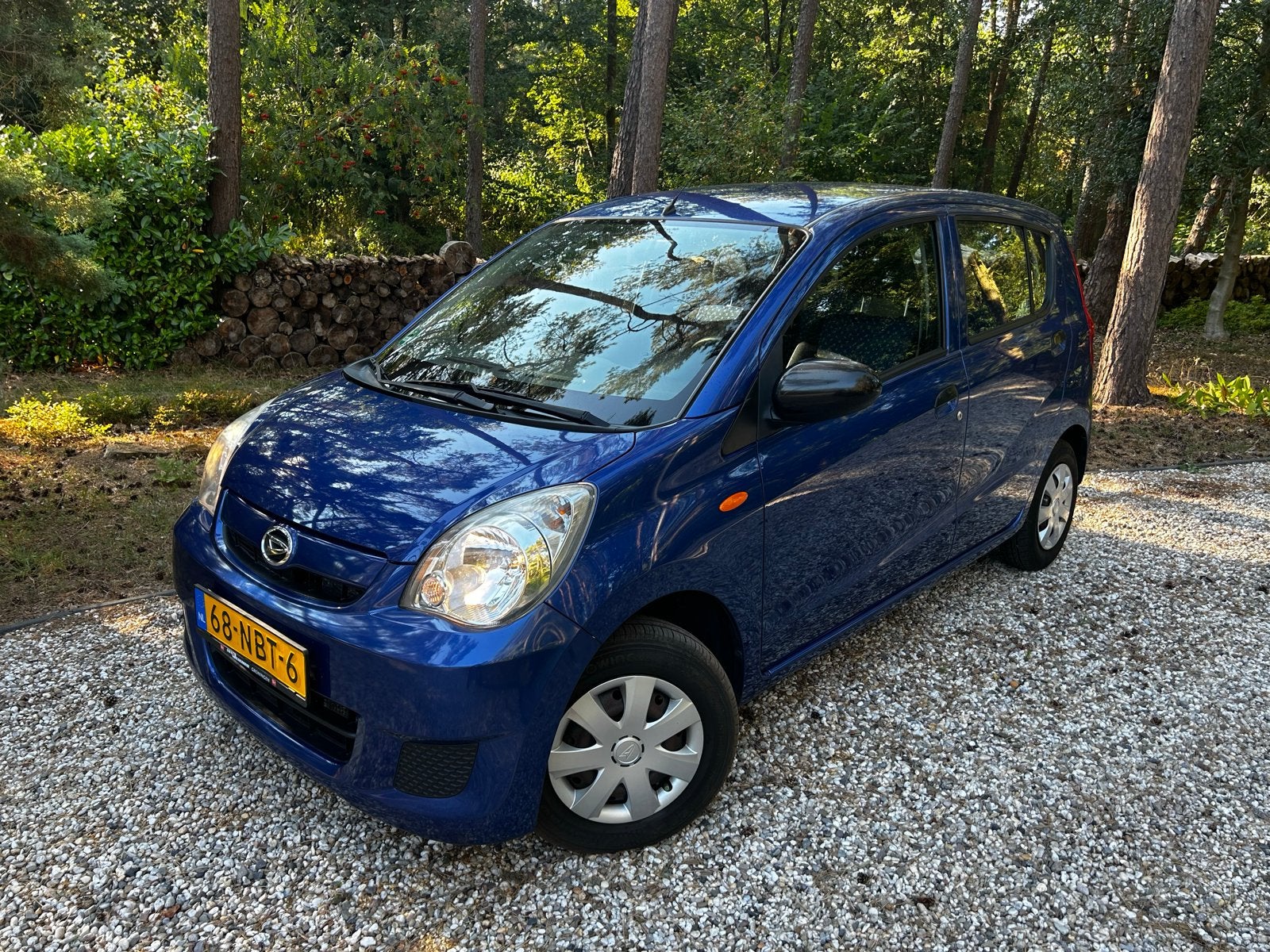 Daihatsu Cuore 1.0 5D 2010 Blauw, Auto's, Daihatsu, Voorwielaandrijving, Stof, 600 kg, Zwart