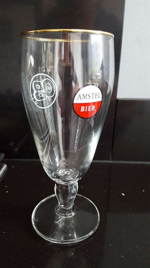 Ongebruikt Uniek 70 jaar oud Amstel Bierglas 60 jaar OB, Verzamelen, Ophalen of Verzenden, Zo goed als nieuw, Glas of Glazen, Amstel