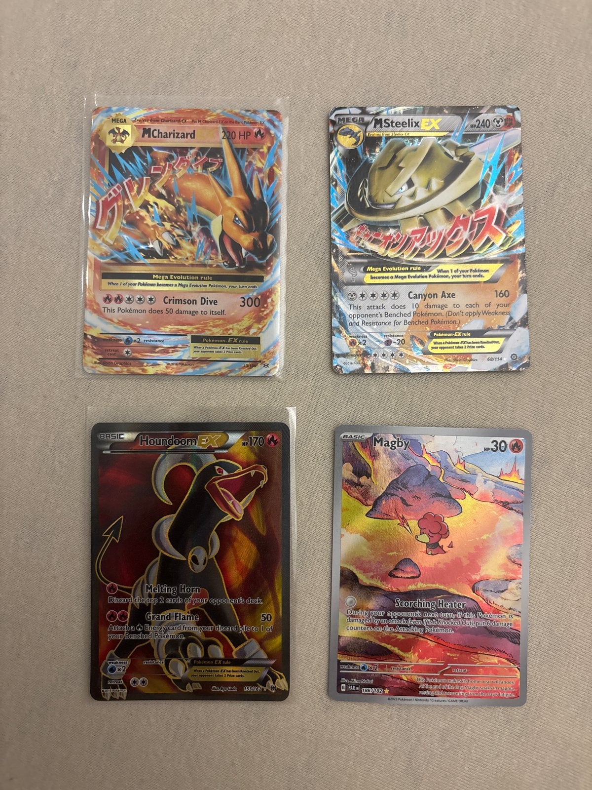Pokémon kaarten: Magby, Charizard, Steelix, Houndoom, Ophalen of Verzenden, Zo goed als nieuw, Meerdere kaarten, Foil