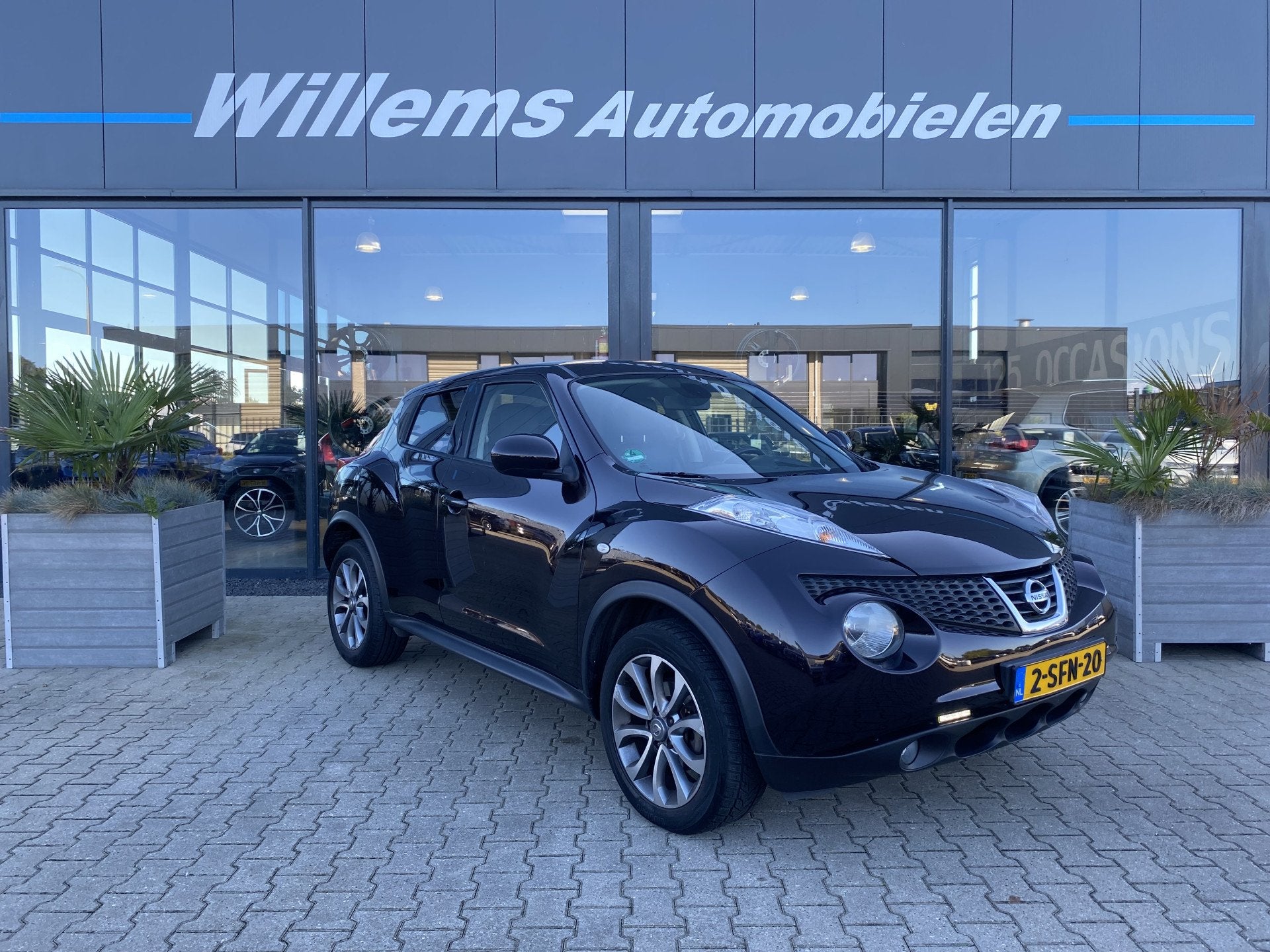 Nissan Juke 1.6 Tekna Cruise Control, Camera & Stoelverwarmi, Auto's, Euro 5, Zwart, 4 cilinders, Met garantie (alle)