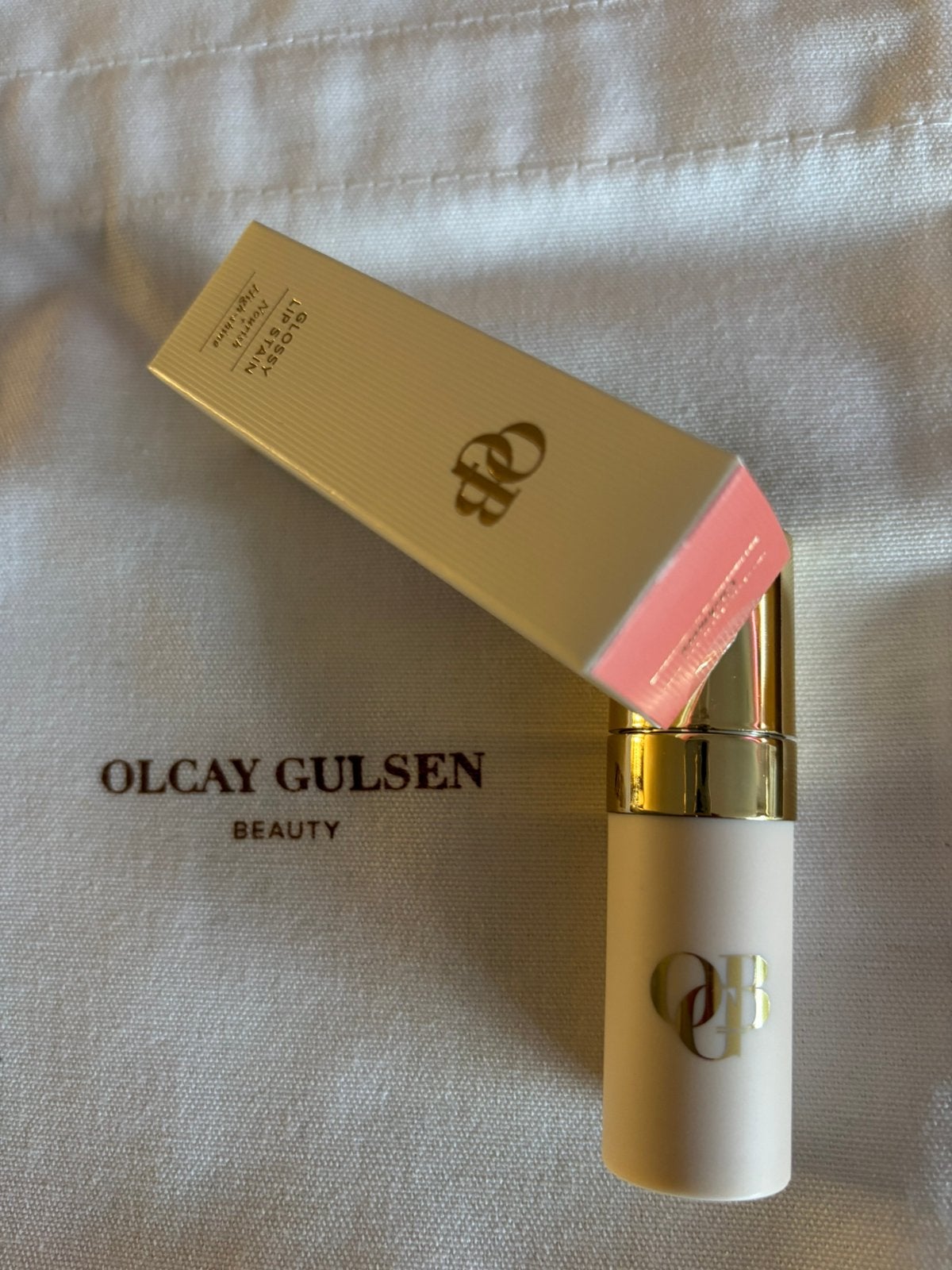 Nieuwe glossy lip stain van Olcay Gulsen, kleur cashmere, Nieuw, Ophalen of Verzenden, Make-up, Overige kleuren