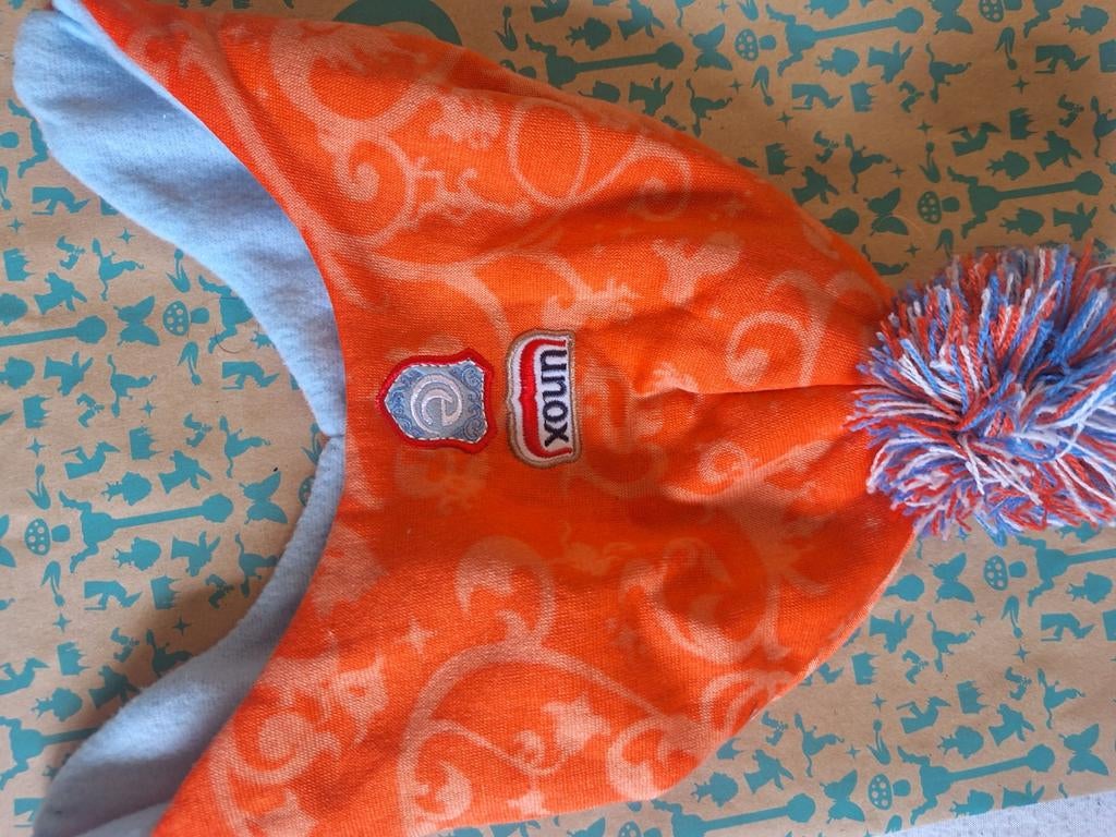 Unox muts met pompon - Oranje met blauwe binnenkant, Ophalen of Verzenden