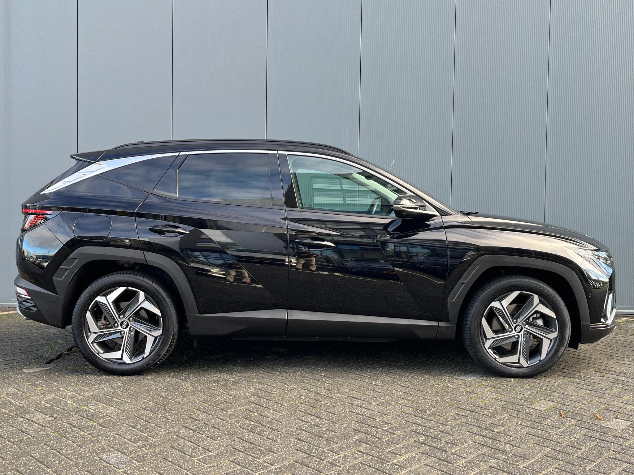 Hyundai Tucson 1.6 T-GDI 265pk PHEV Premium 4WD, Auto's, Gebruikt, 4 cilinders, Zwart, Vierwielaandrijving