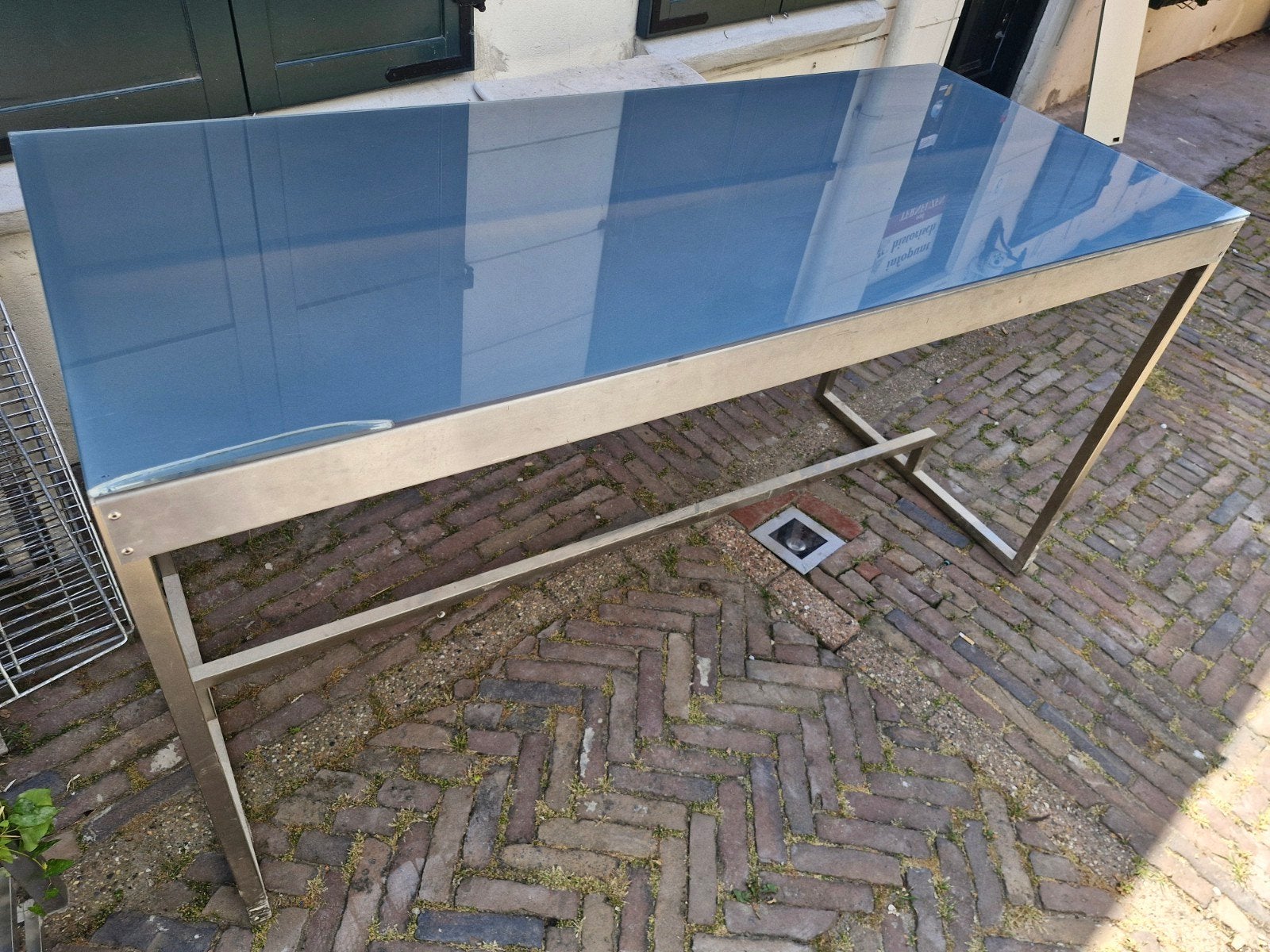 Moderne eettafel met glazen blad en metalen onderstel, Ophalen of Verzenden