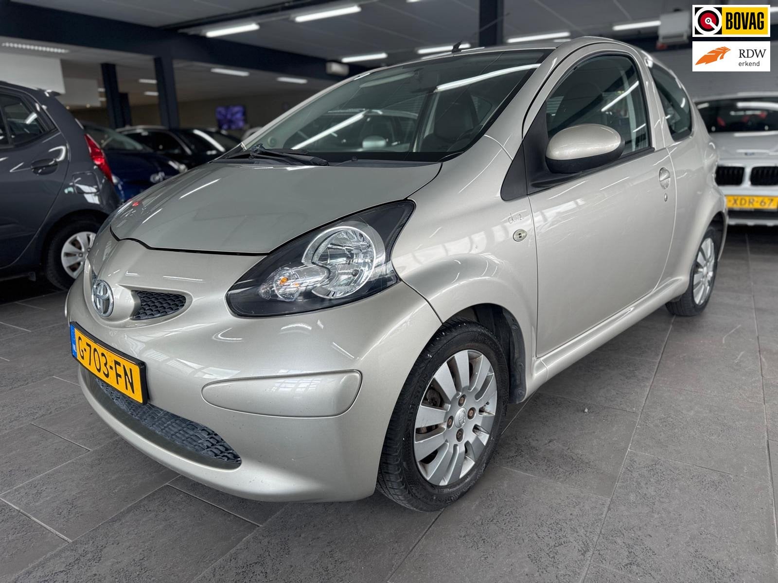 Toyota Aygo 1.0-12V + airco elektrische pakket half leer lm-, Auto's, Voorwielaandrijving, Gebruikt, Bruin, 4 stoelen