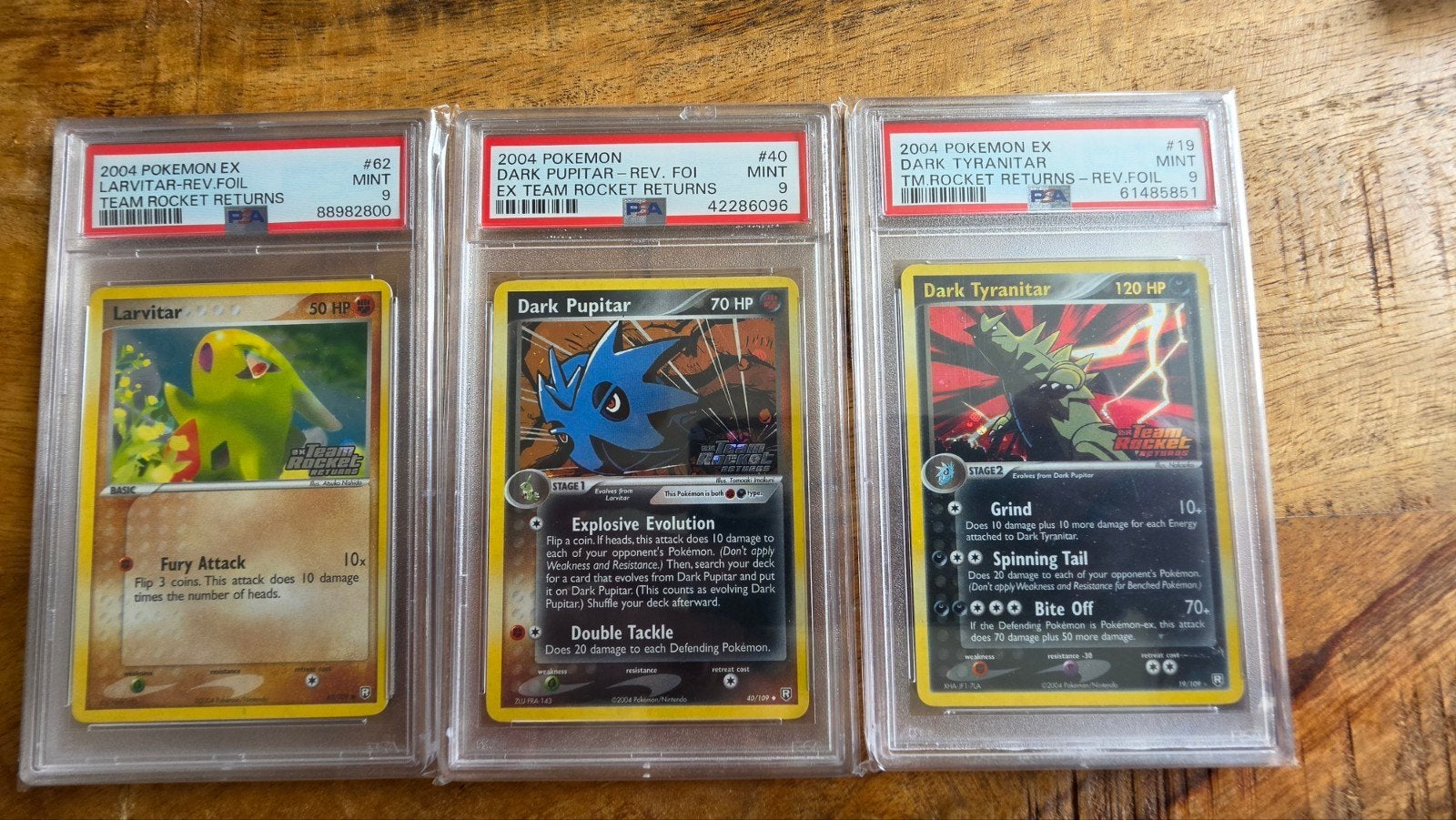 PSA 9 Pokémon Team RocketLarvitar, Pupitar, Tyranitar set, Ophalen of Verzenden, Zo goed als nieuw, Meerdere kaarten, Foil