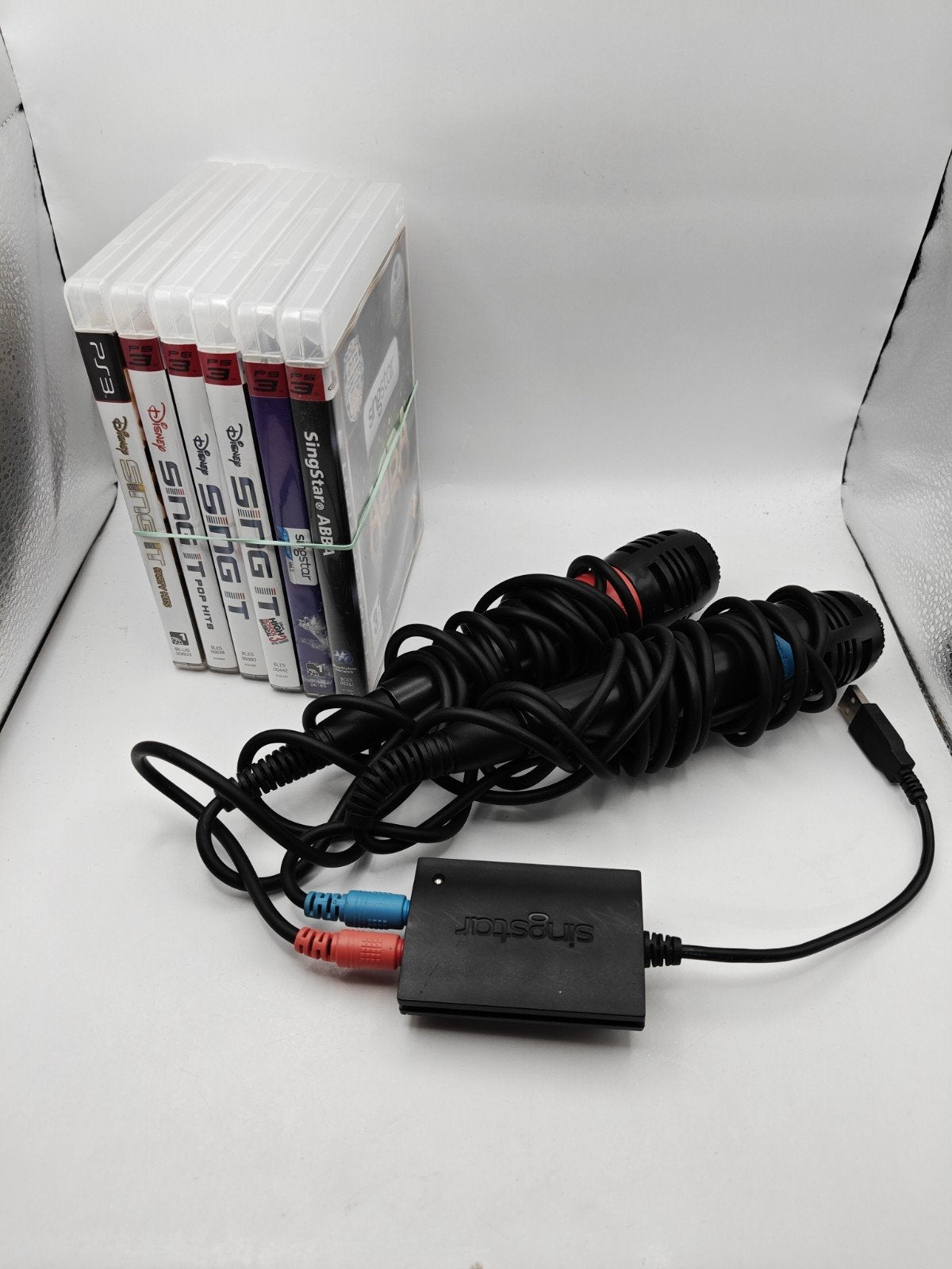 SingStar en Sing It PS3 bundel: 2 microfoons en 6 spellen, Muziek, Gebruikt, 10 Great Marlborough Street, London, W1F 7LP, UK