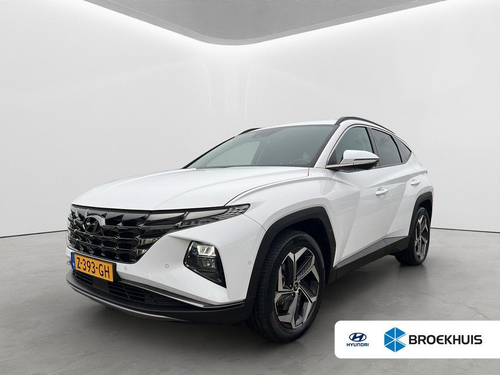 Hyundai Tucson 1.6 T-GDI 265pk PHEV Premium 4WD, Auto's, Gebruikt, 4 cilinders, Wit, Bedrijf