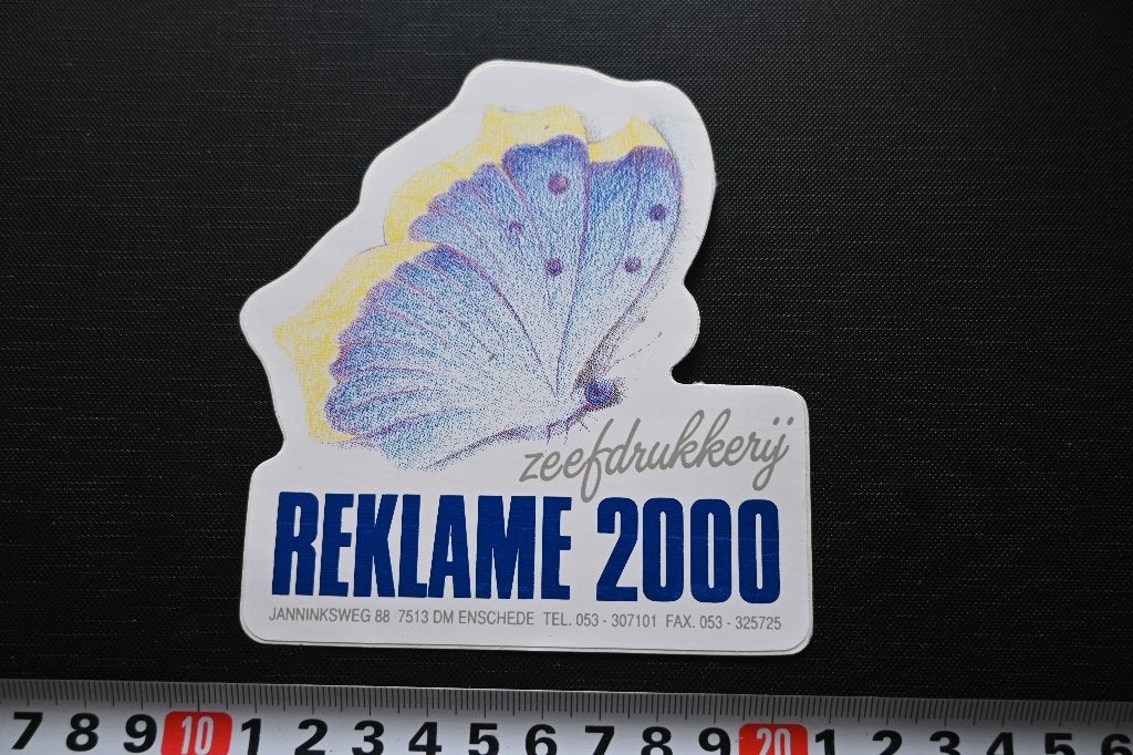 sticker enschede zeefdrukkerij REKLAME 2000 strip vlinder, Ophalen, Zo goed als nieuw