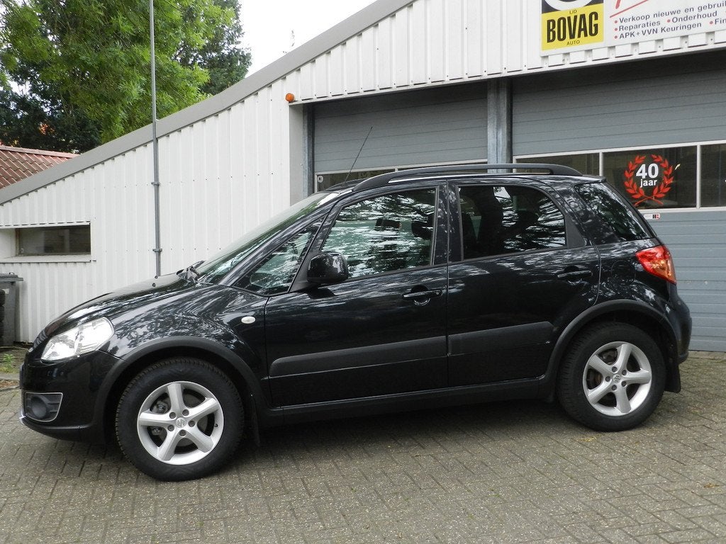 Suzuki SX4 1.6 AWD 4X4 Comfort 5Drs Airco Navigatie LMV Alca, Euro 5, Gebruikt, Zwart, 4 cilinders