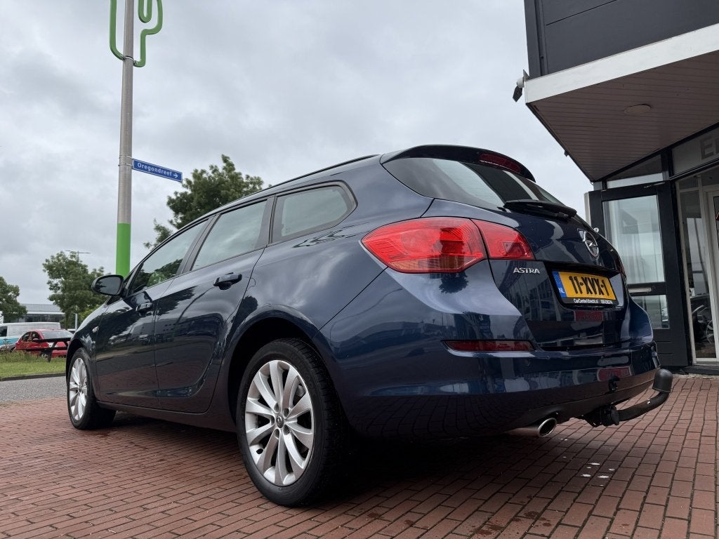 Opel Astra Sports Tourer 1.4 Turbo Edition | trekhaak | airc, Auto's, Gebruikt, 4 cilinders, Blauw, Origineel Nederlands