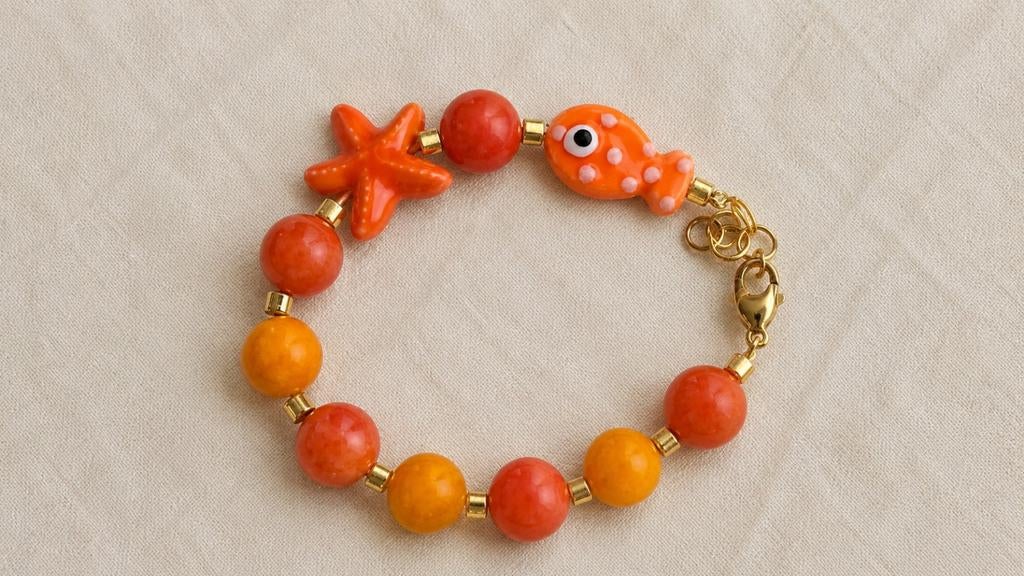 Oranje armband met jade kralen, zeester & vis bedels, Overige materialen, Nieuw, Oranje, Ophalen of Verzenden