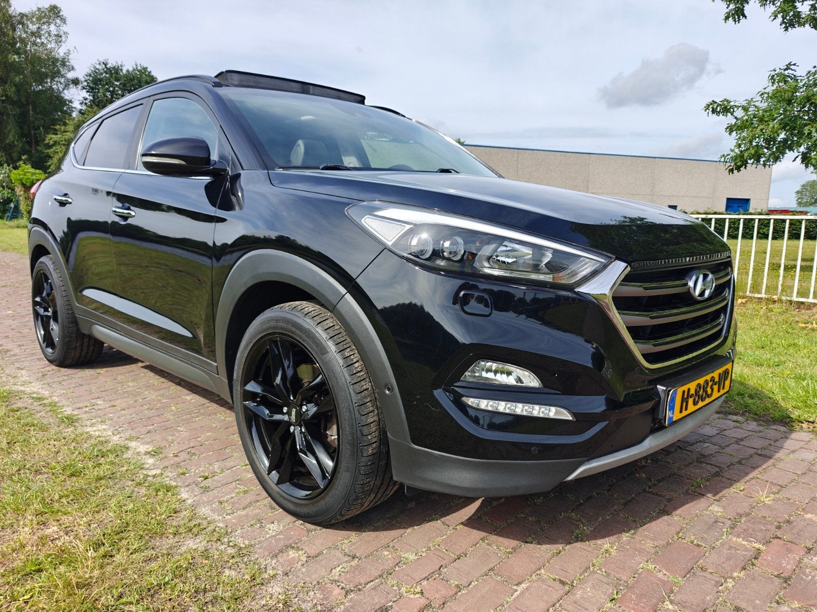 Hyundai Tucson 1.6 T-GDI AUT. 4WD 2017 Zwart Panorama Trekha, Auto's, Lichtsensor, 4 cilinders, Zwart, Leder