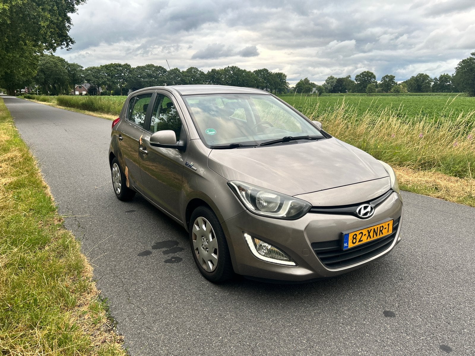 Hyundai i20 1.2I 5-DRS 2012 Bruin, Auto's, Hyundai, 450 kg, 4 cilinders, Bruin, Origineel Nederlands