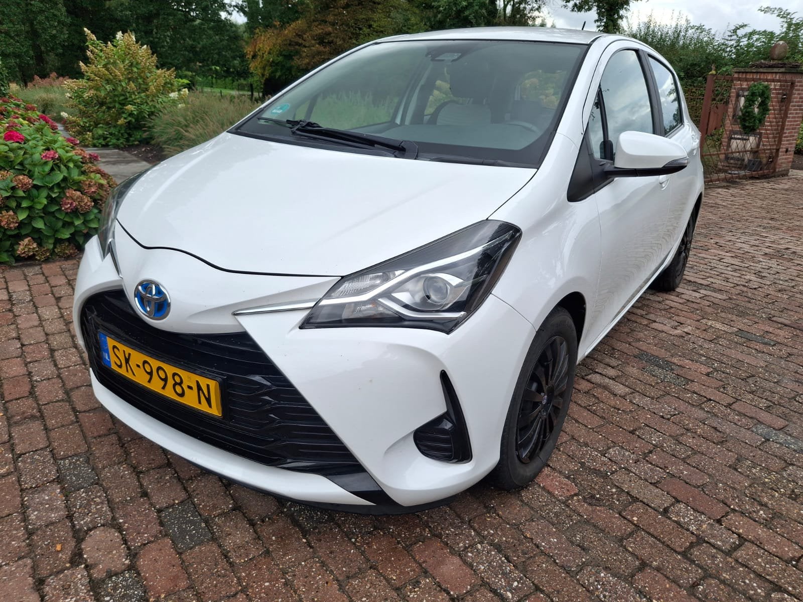Toyota Yaris 1.5 Hybrid 100pk 5D CVT 2018 Wit, Auto's, 1497 cc, Origineel Nederlands, 1065 kg, Te koop