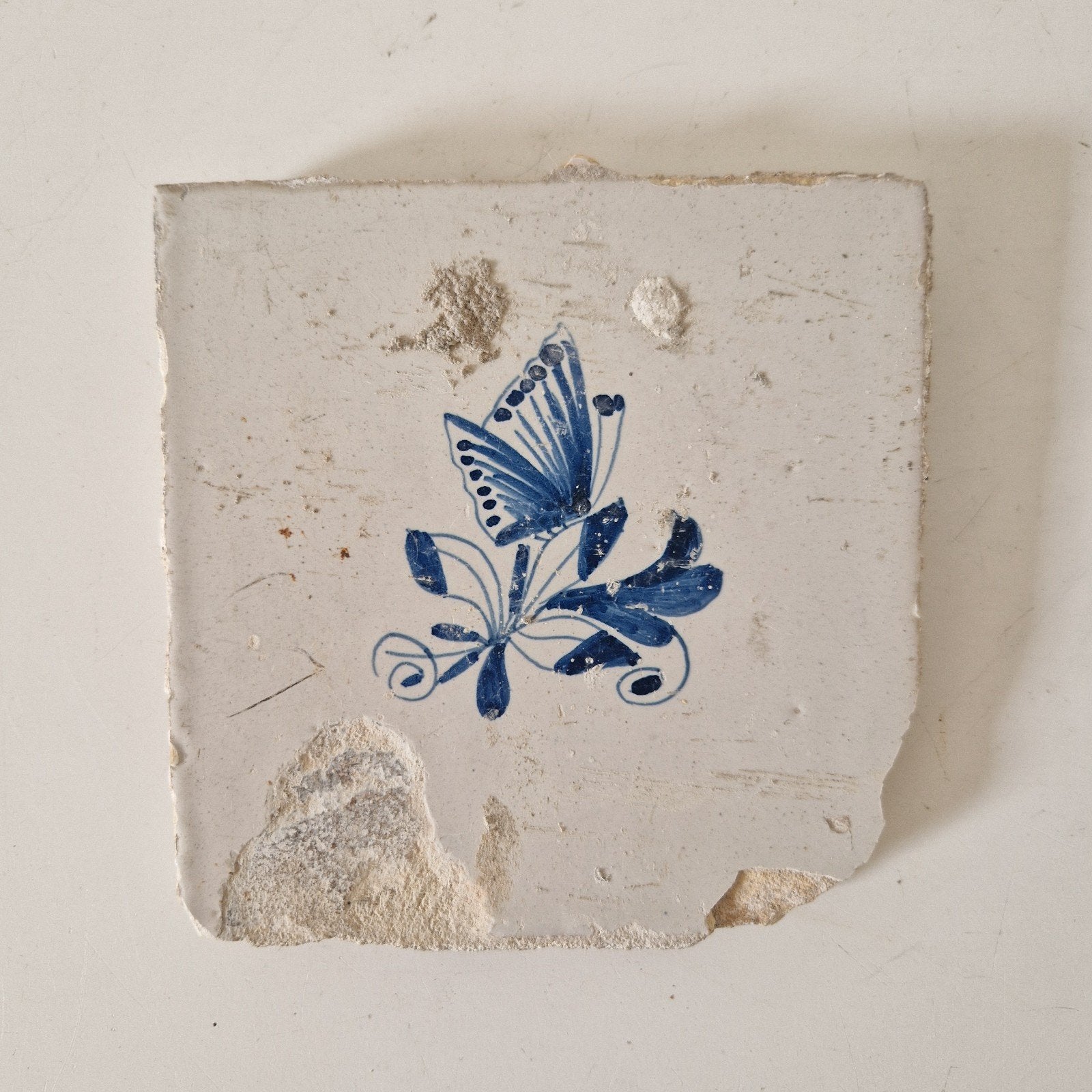 Antieke tegel met bloemen en vlinder, Ophalen of Verzenden