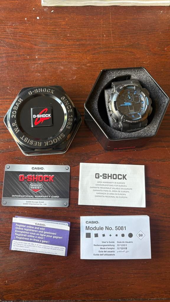 Casio G-Shock GA-100-1A2 zwart/blauw + doos & papieren, Sieraden, Tassen en Uiterlijk, Horloges | Heren, Casio, Kunststof, Polshorloge