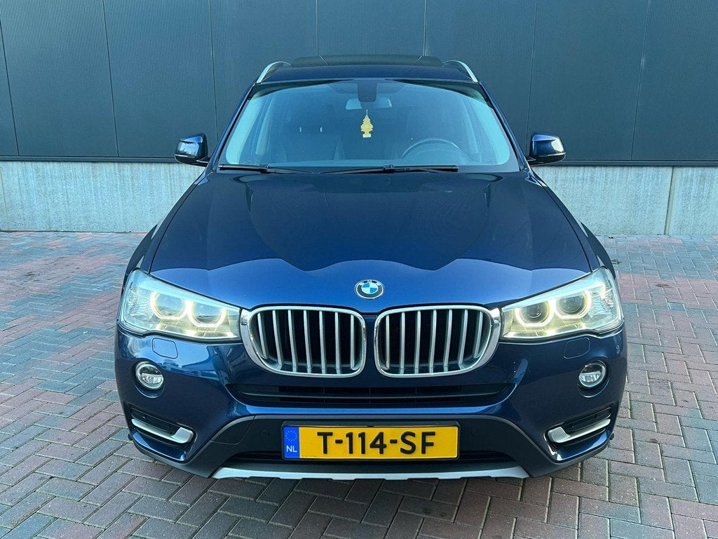 BMW X3 XDrive20d High executive X-Line * Aut * Navi * Cruise, Automaat, Zwart, Blauw, Leder en Stof