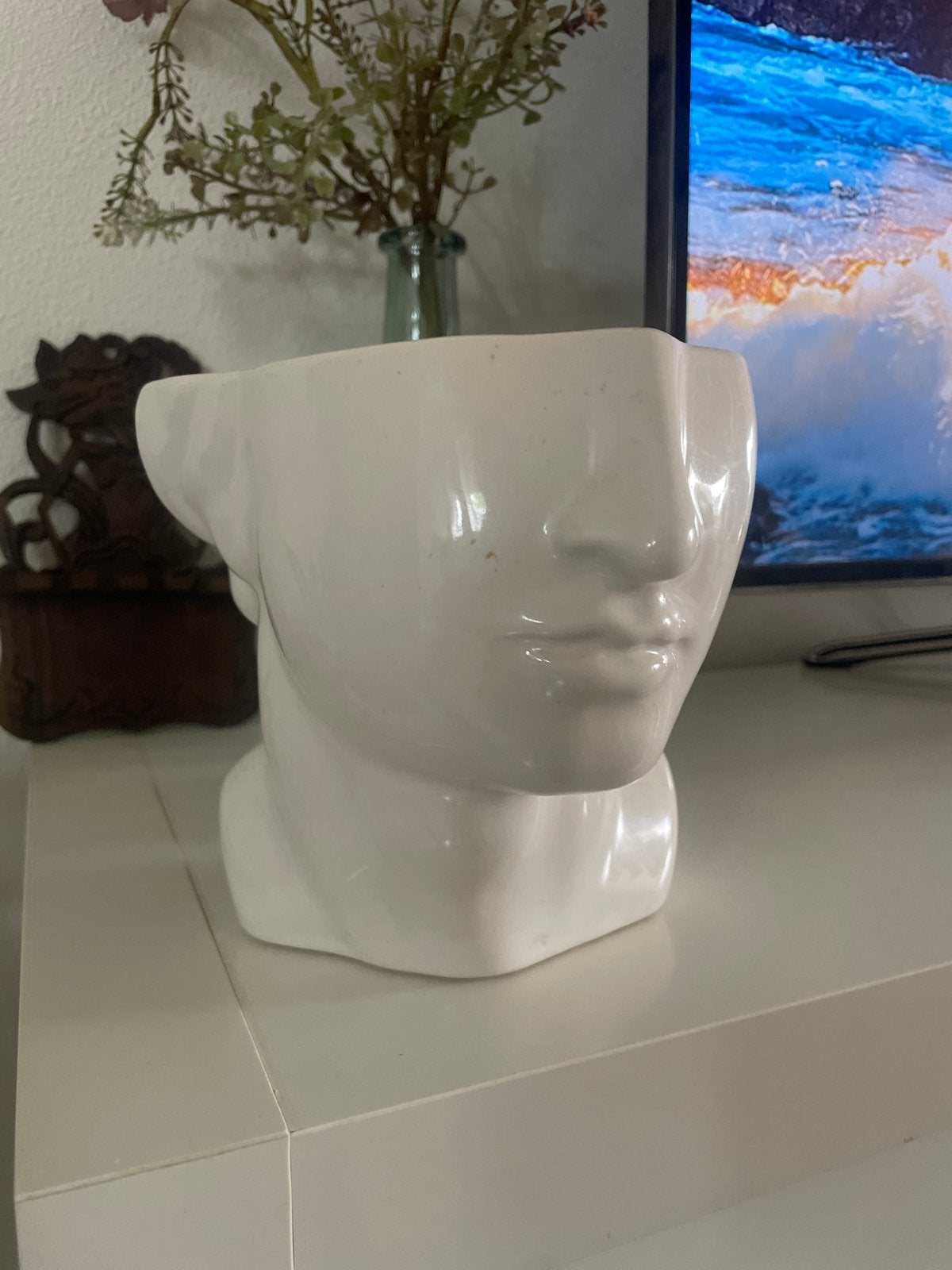 Witte plantenbak in de vorm van een hoofd, Ophalen