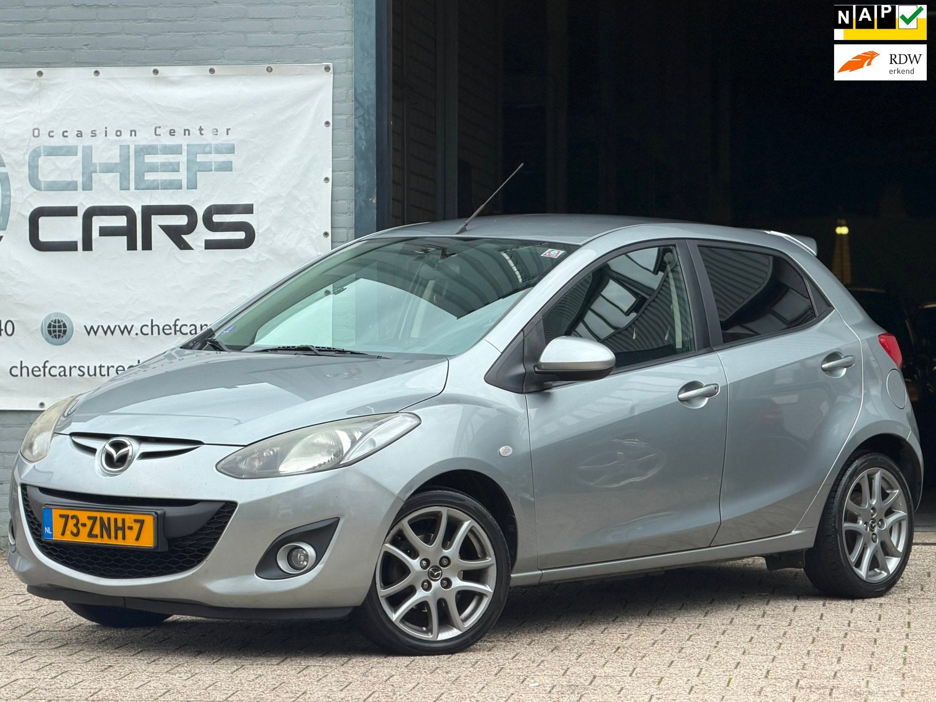 Mazda 2 1.3 GT|NAP|AIRCO|5DEURS|BOEKJES|STOELVW|LM|TREKHAAK!, Voorwielaandrijving, Euro 5, Zwart, 4 cilinders