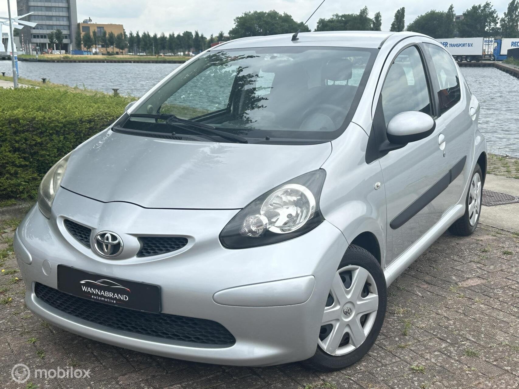 Toyota Aygo 1.0-12V Dynamic Navigator, Auto's, Voorwielaandrijving, Euro 5, Stof, Gebruikt