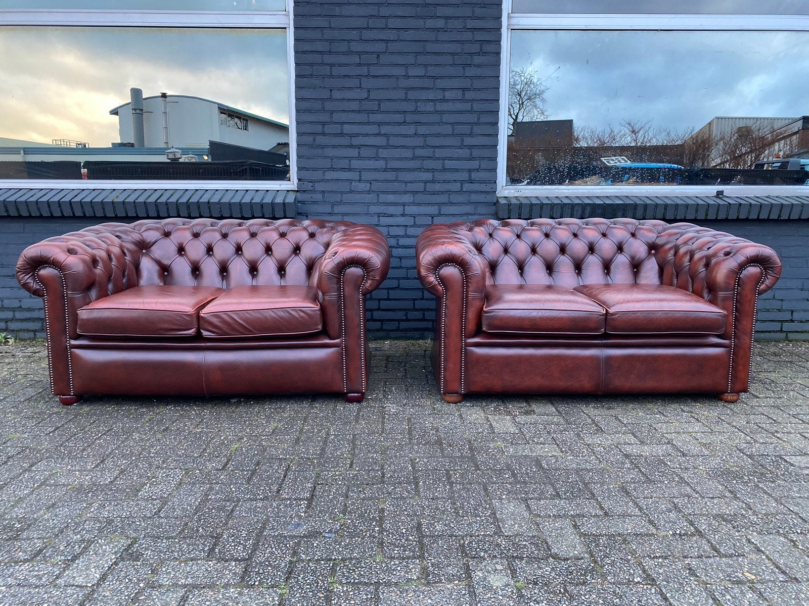 Twee Engels Chesterfield banken roodbruin, Ophalen, 125 cm of meer, Leer, Zo goed als nieuw