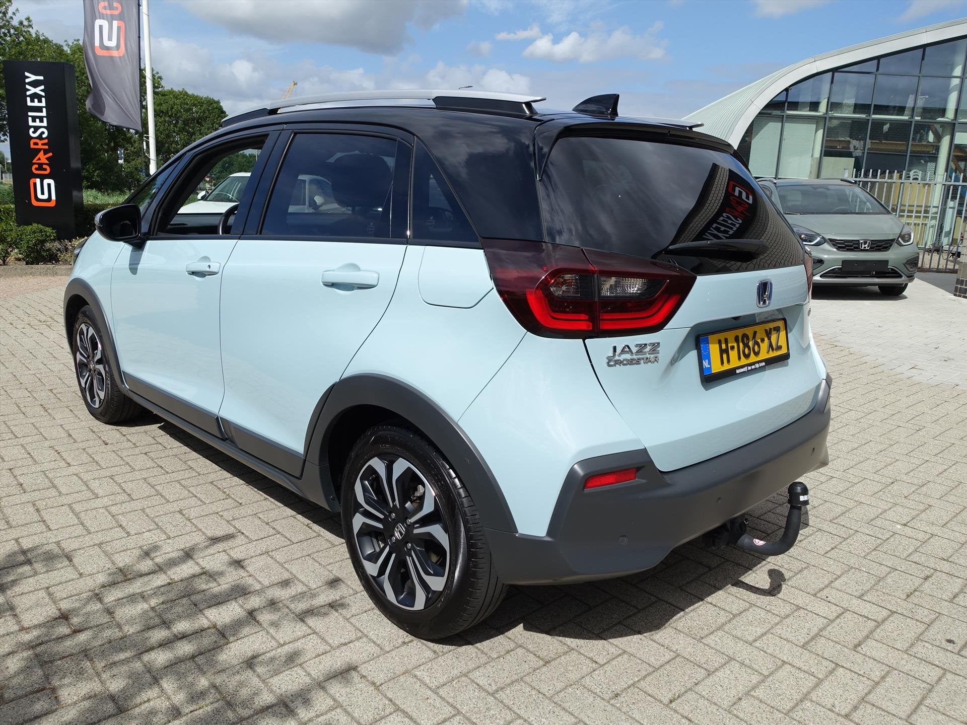 HONDA Jazz 1.5 i-MMD 109pk Hybrid CVT Crosstar Zwart Dak en, Auto's, Honda, Stof, 4 cilinders, Blauw, Bedrijf