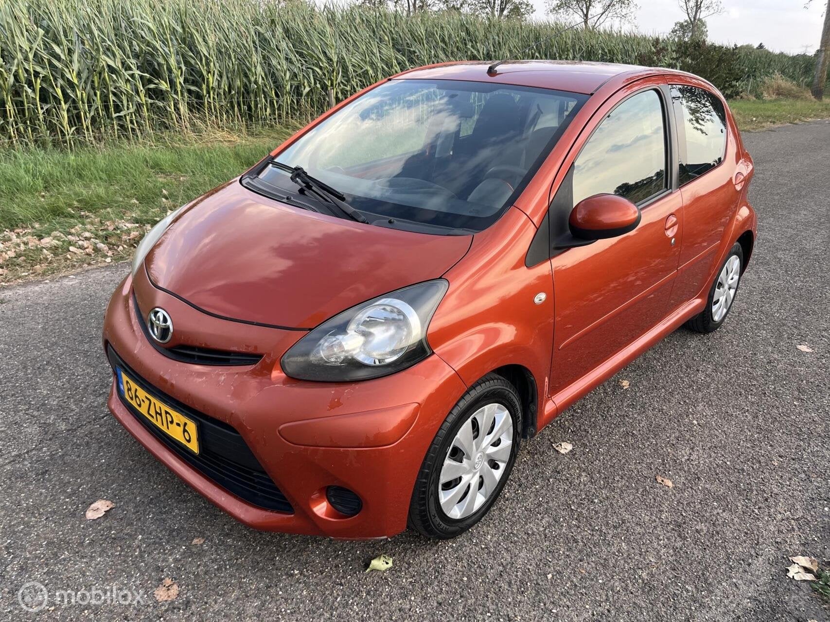 Toyota Aygo 1.0 VVT-i Comfort Orange Airco/5 Drs/Apk 8-2027, Voorwielaandrijving, Euro 5, Stof, Gebruikt