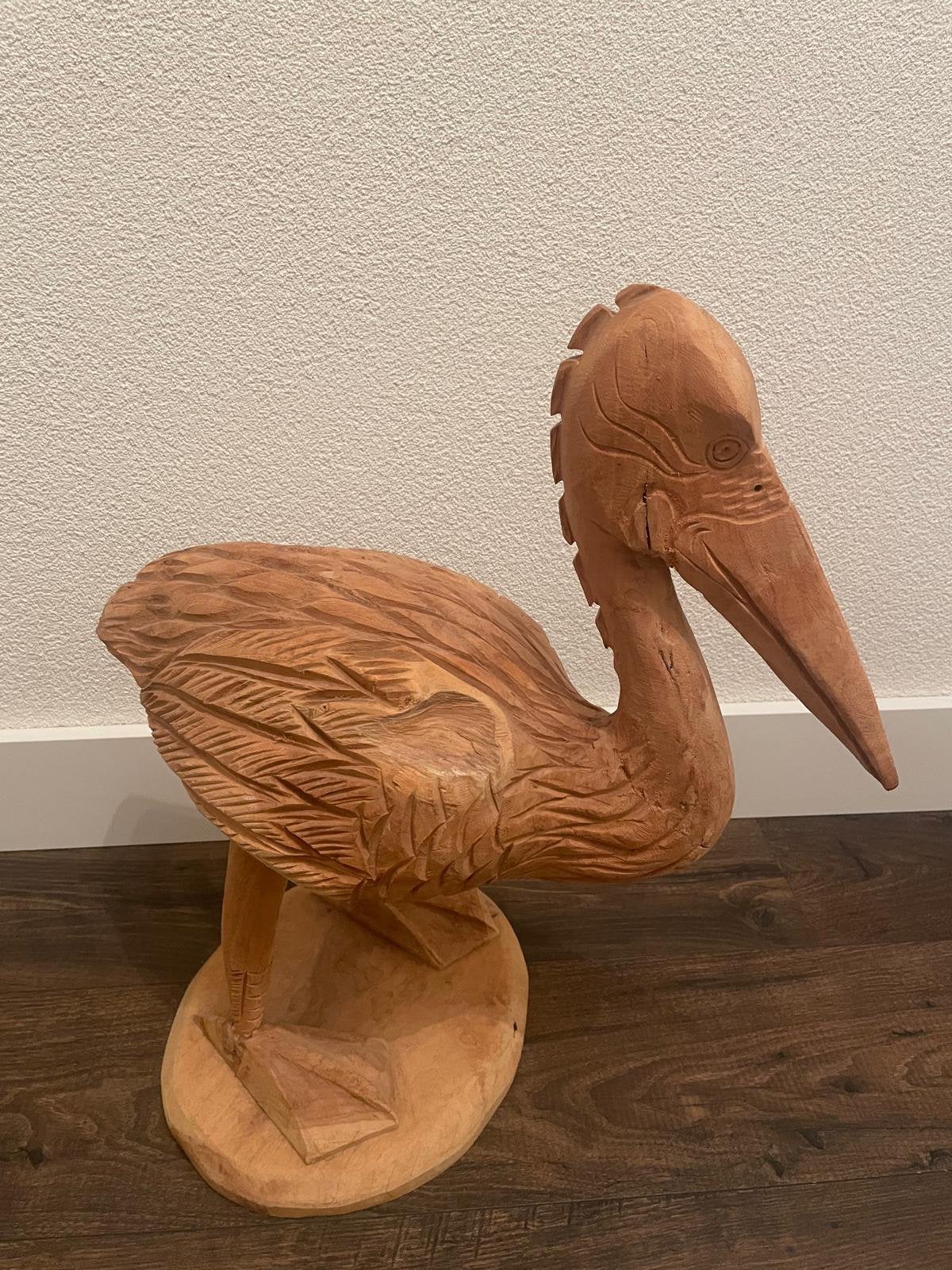Teak houten pelikaan, Ophalen