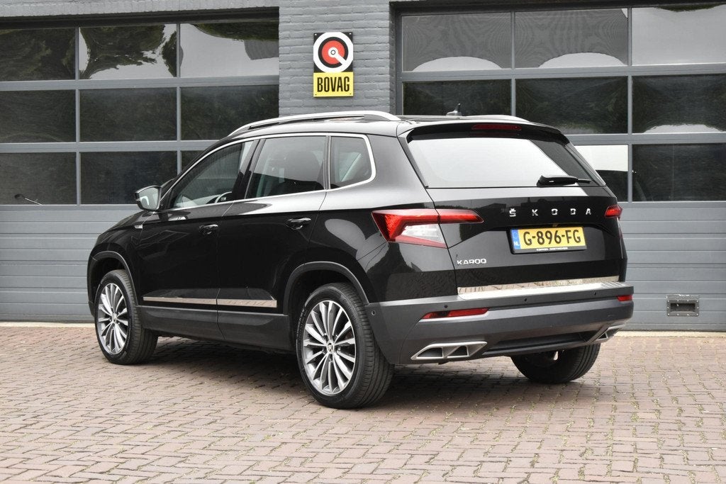 Skoda Karoq 1.5 TSI Sportline Business Edition, Auto's, Skoda, 12 maanden, 4 cilinders, Automatische klimaatregeling, Zwart