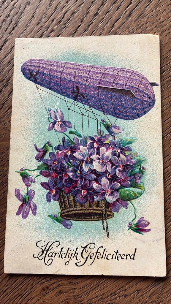 GERESERVEERD!Soort zeppelin met mand paarse bloemen.Reliëf, Ophalen of Verzenden, Voor 1920, Gelopen, Overige thema's