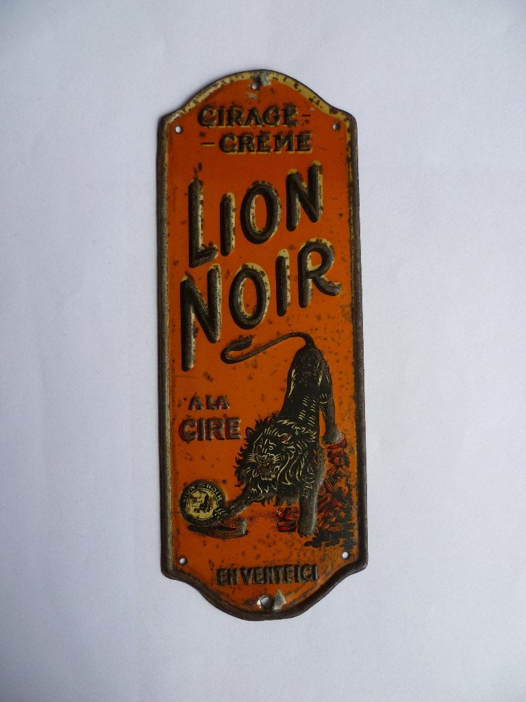BLIKKEN DEURPOSTJE"LION NOIR EN VENTE ICI"UIT JAREN 30/40, Ophalen of Verzenden, Gebruikt, Reclamebord