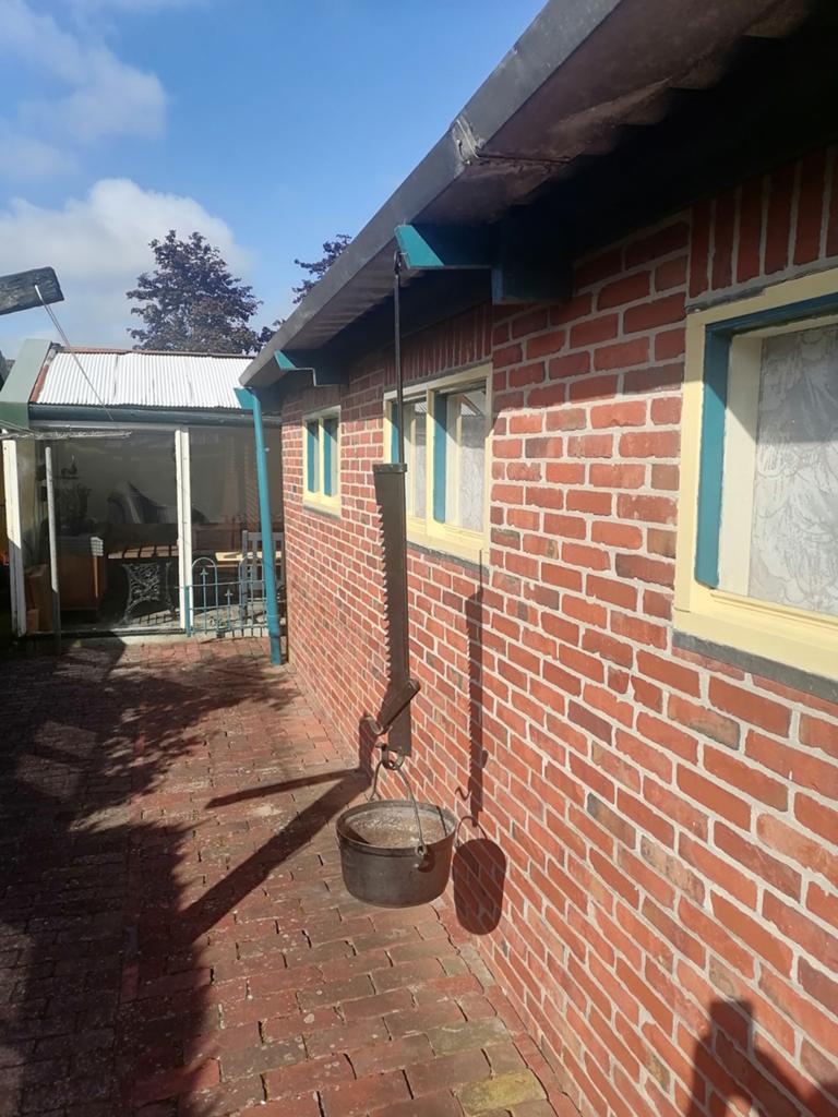 Smeedijzeren haardijzer met gietijzeren kookpot, Ophalen