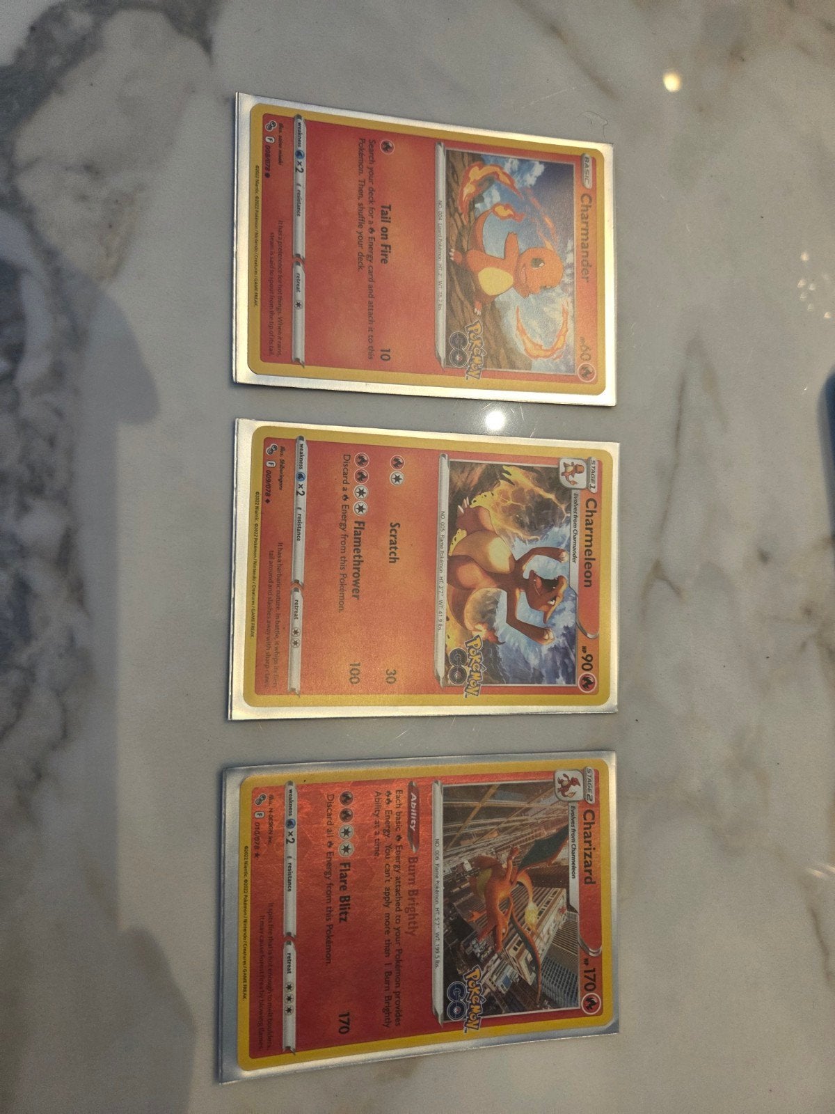 Pokémon GO Charmander, Charmeleon, Charizard Evolutie Set, Ophalen of Verzenden, Zo goed als nieuw, Meerdere kaarten