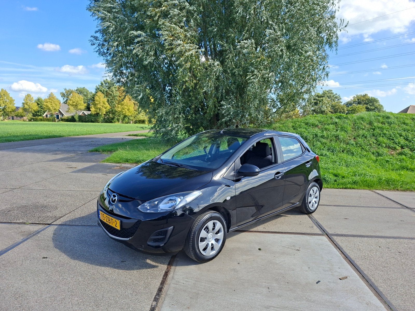 Mazda 2 1.3 Bifuel 145000 km bj 2012, Auto's, Voorwielaandrijving, 74 pk, 4 cilinders, Zwart