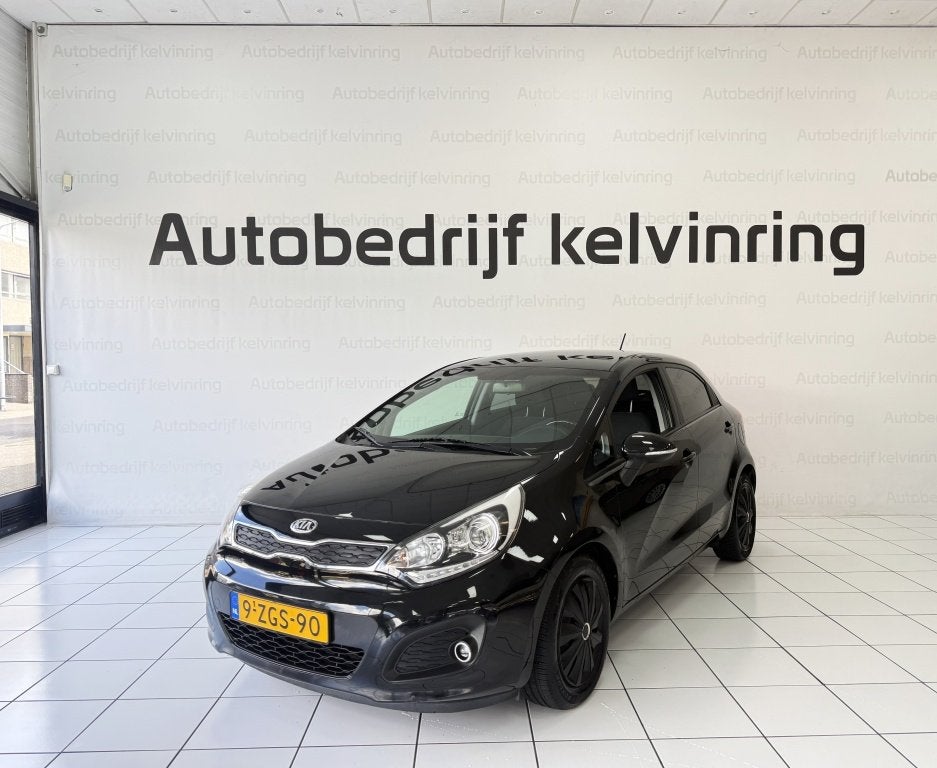 Kia Rio 1.2 CVVT Executive Bovag Garantie NAP (bj 2015), 21 km/l, Parkeersensor, 4 cilinders, Zwart