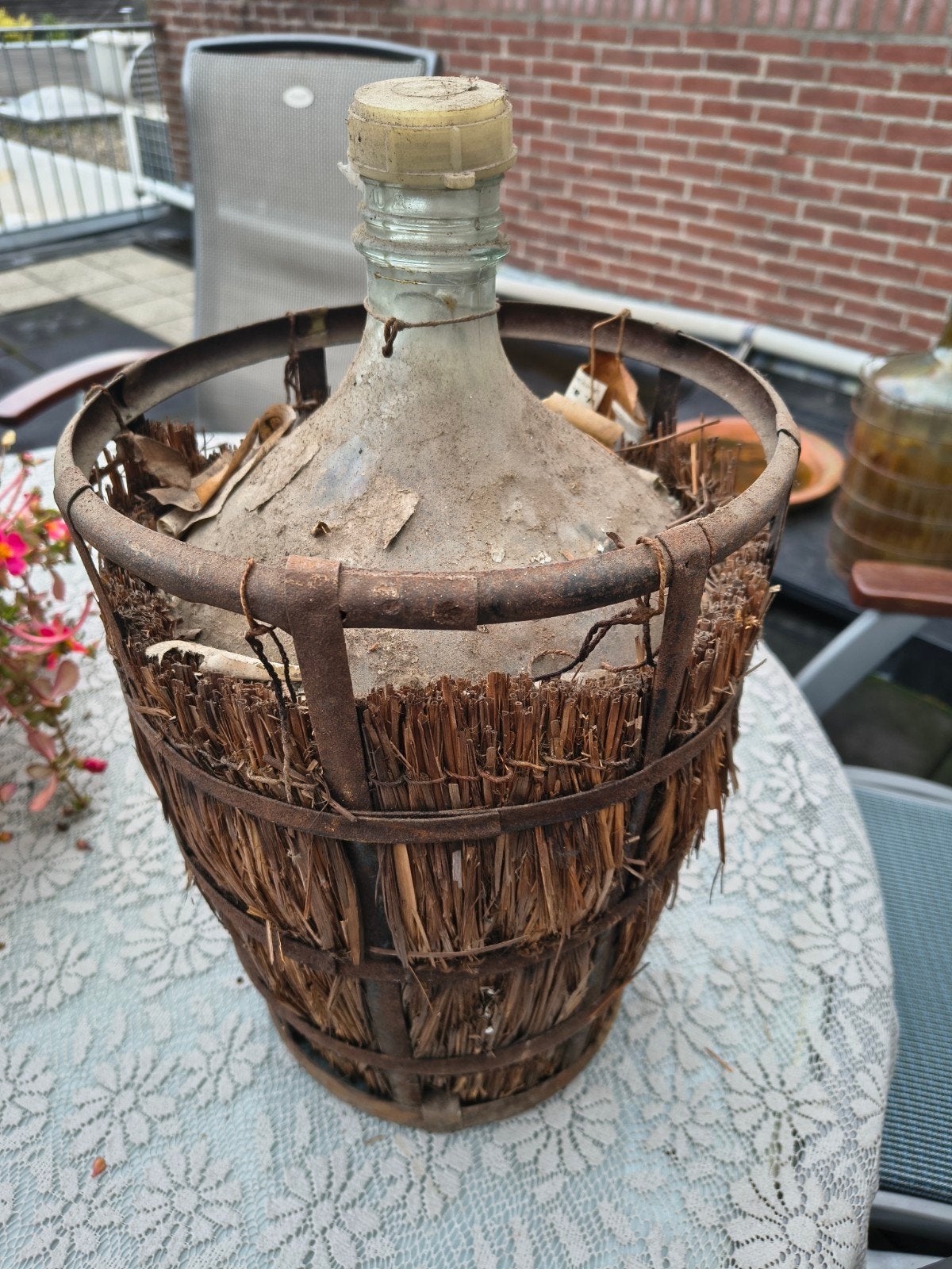 Antieke mandfles met rieten omhulsel, Ophalen